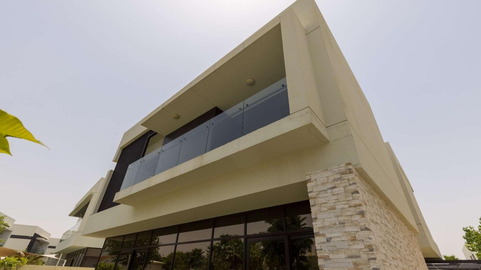 Modern living room in luxury Silver Springs villa, Damac Hills, with elegant decor and staircase