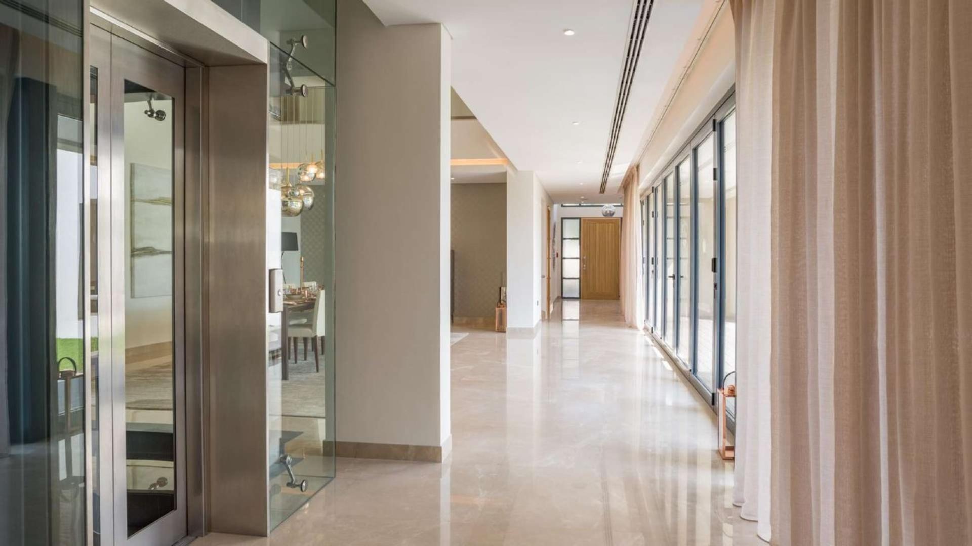 Luxurious bedroom in Sobha Hartland villa, featuring modern decor and elegant furnishings