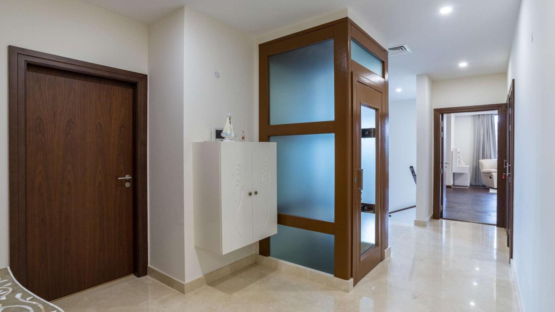 Luxurious living room with waterfront view in Palm Jumeirah villa, Garden Homes