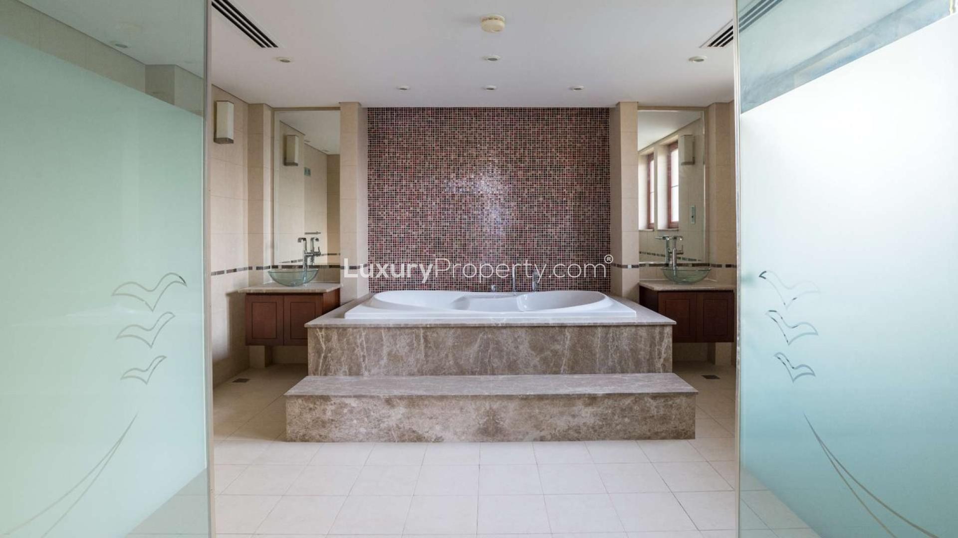 Spacious living room with large windows and lake view in Jumeirah Islands villa