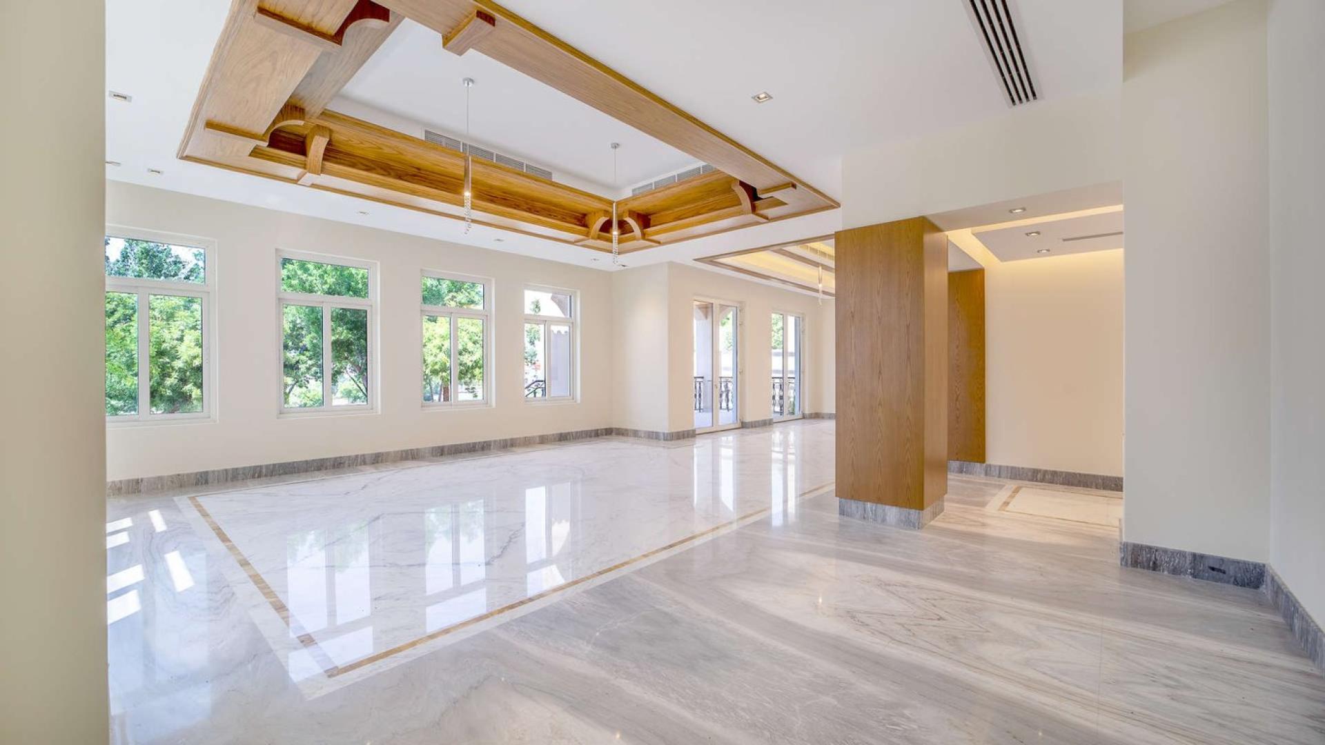 Luxurious villa interior with marble floors and wooden ceiling in Jumeirah Golf Estates