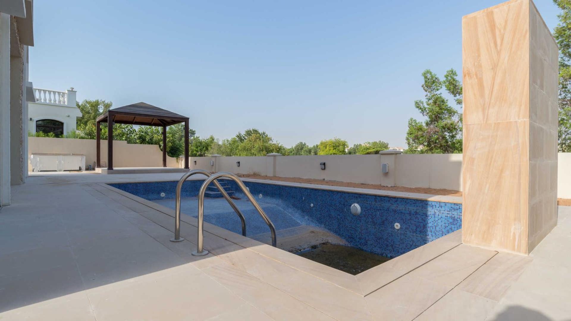 Bright, spacious living room in five-bedroom villa, Jumeirah Golf Estates, marble floors, large windows