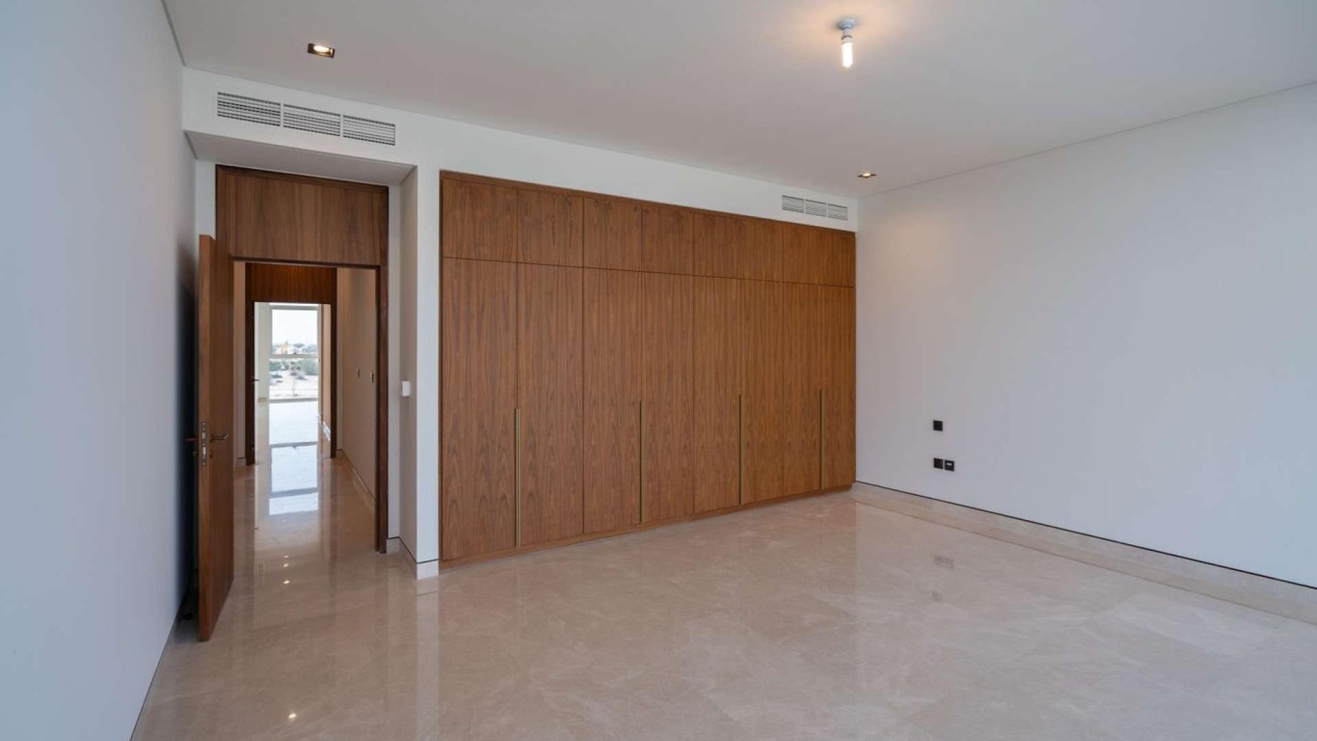 Spacious bedroom with built-in wooden closets in Dubai Hills Estate villa for sale