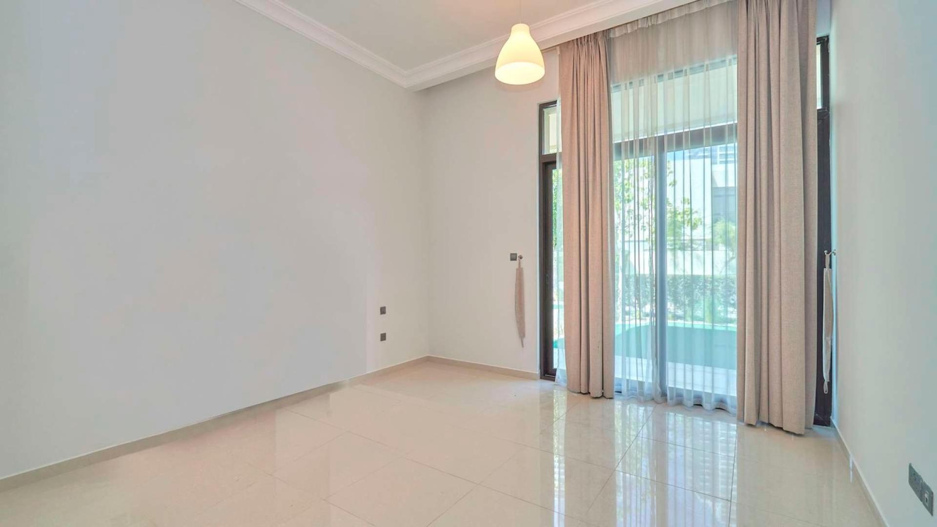 Stunning Brookfield villa exterior with lawn and pergola, Damac Hills real estate for sale