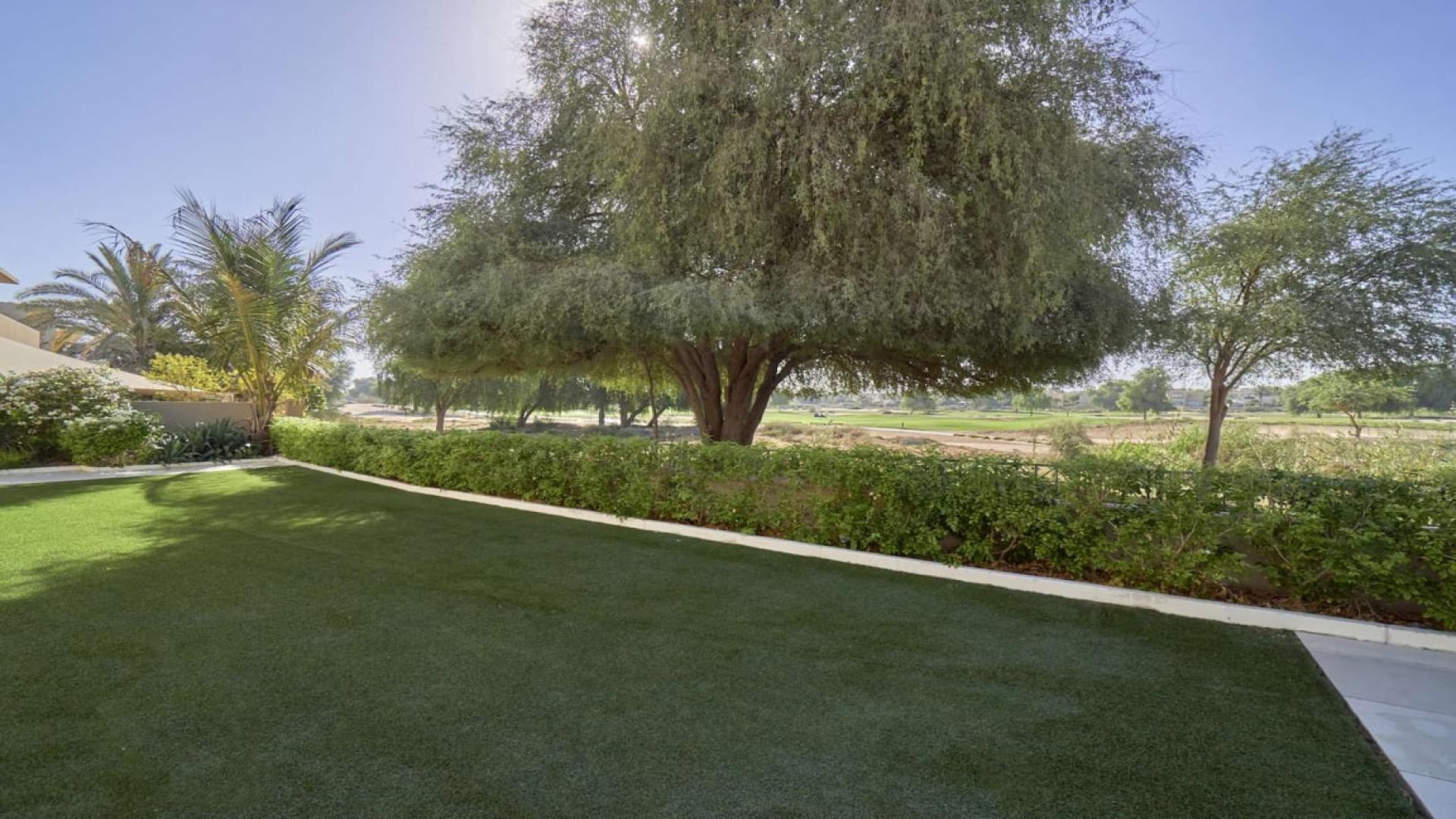 Dining area in upgraded villa, Savannah, Arabian Ranches with garden view through glass doors