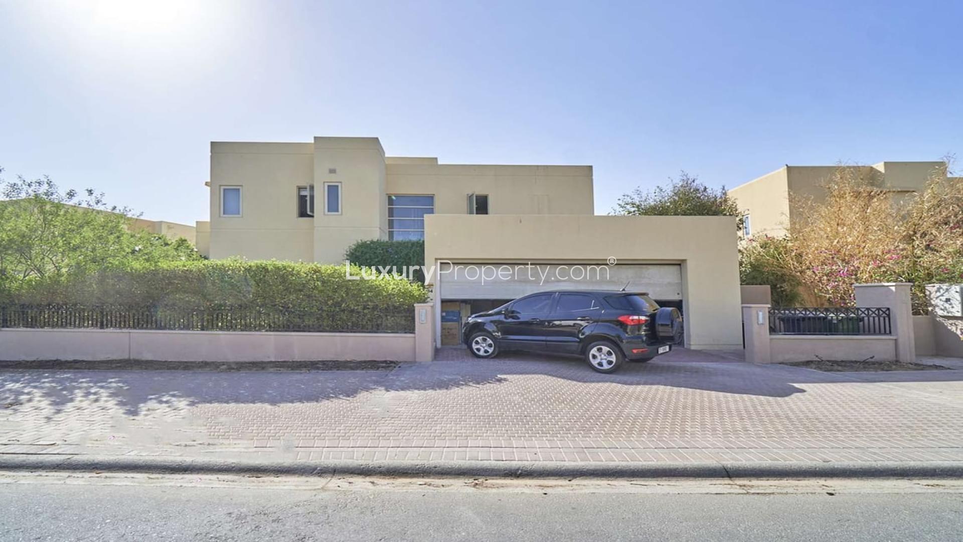 Upgraded villa backyard with lush garden and golf course view in Arabian Ranches, Savannah