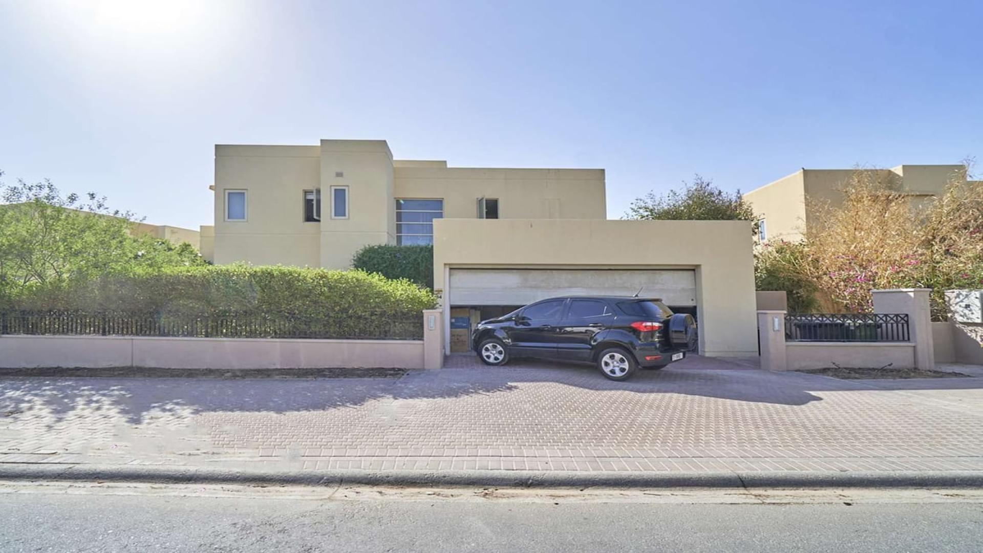 Upgraded villa backyard with lush garden and golf course view in Arabian Ranches, Savannah