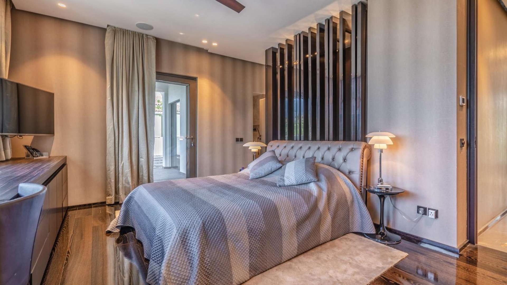 Luxurious living room in 5-bedroom villa, Palm Jumeirah, featuring elegant decor and chandelier