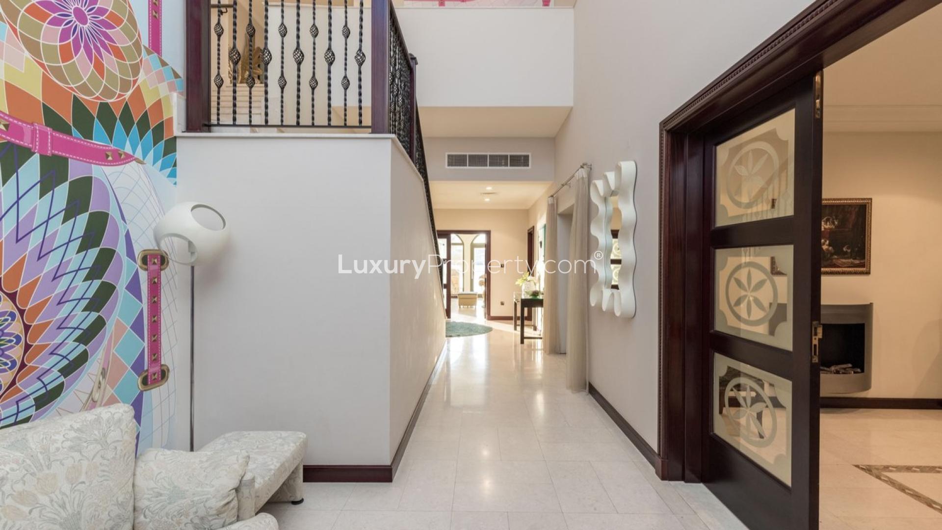 Outdoor pool with waterfront views at luxurious Palm Jumeirah villa for sale