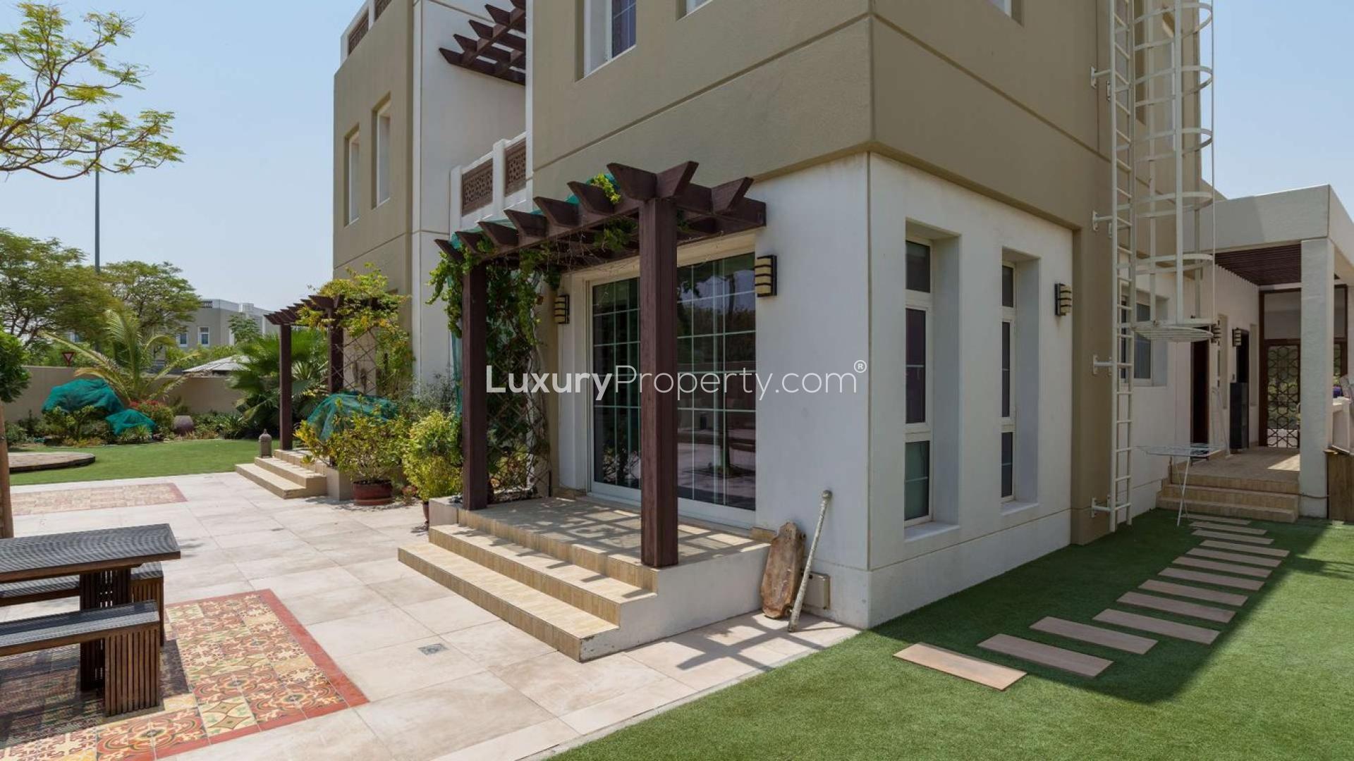 Corner villa on large plot in Rahat, Mudon, featuring modern architecture and lush greenery