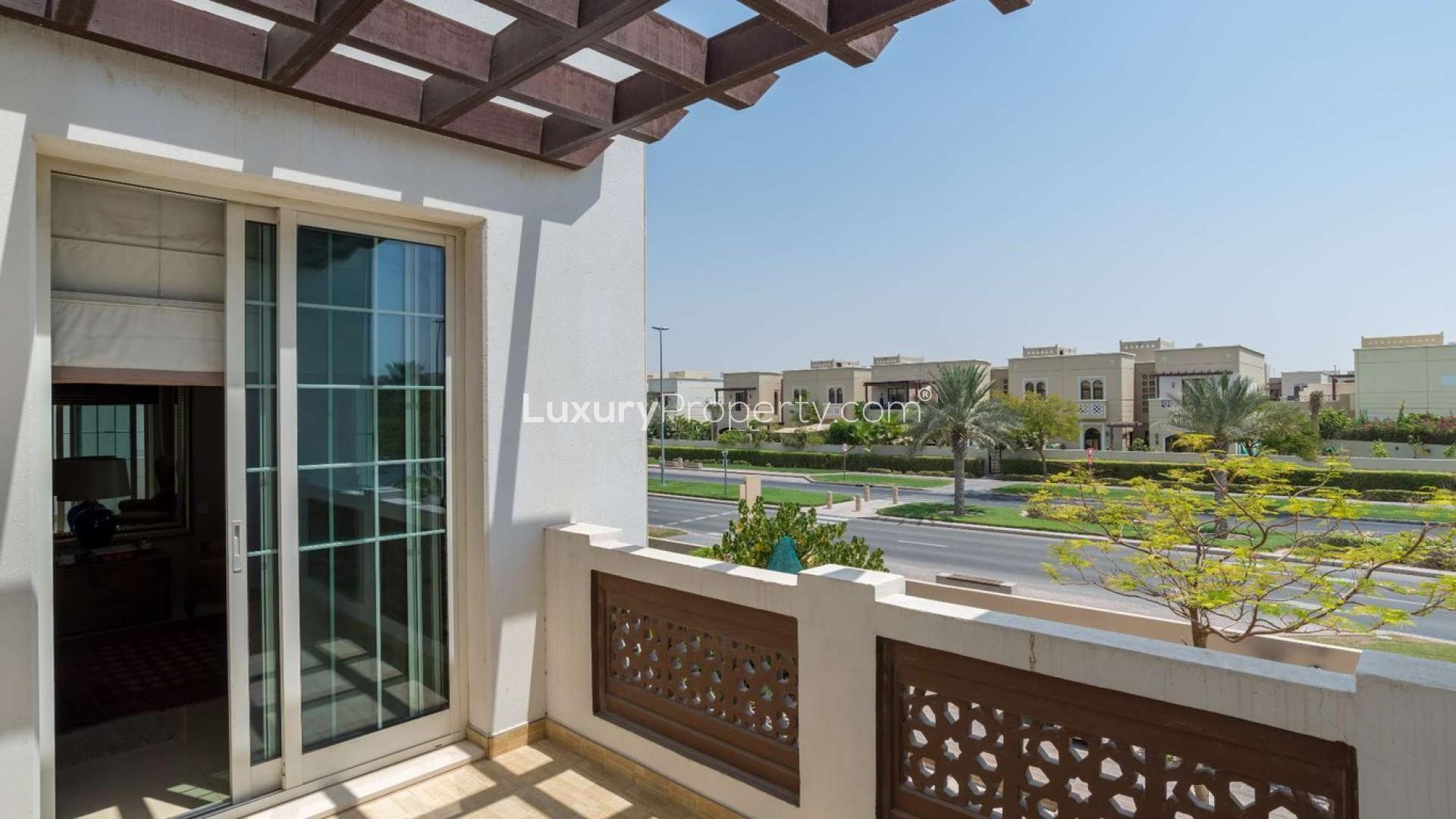 "Elegant 5-bedroom villa exterior in Rahat, Mudon, featuring modern design and lush landscaping.",Balcony view from 5-bedroom villa for sale in Rahat, Mudon, showcasing neighborhood