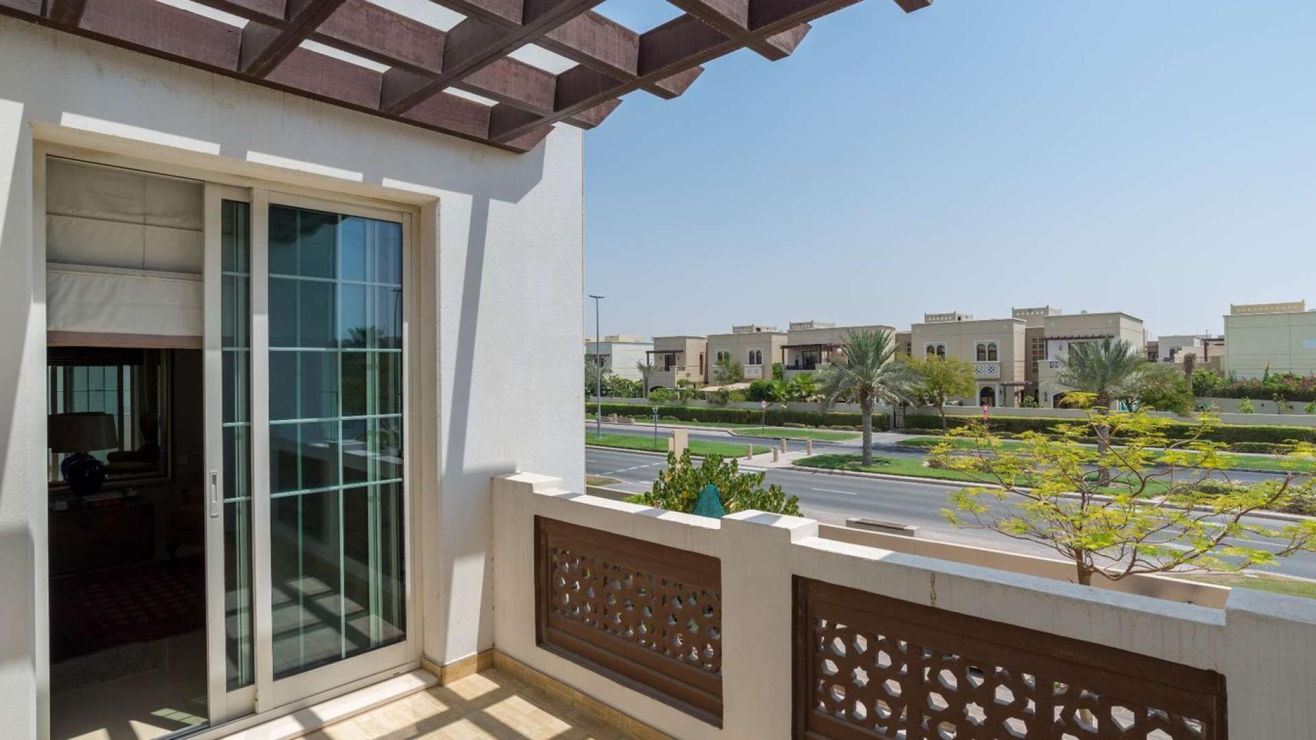 "Elegant 5-bedroom villa exterior in Rahat, Mudon, featuring modern design and lush landscaping.",Balcony view from 5-bedroom villa for sale in Rahat, Mudon, showcasing neighborhood