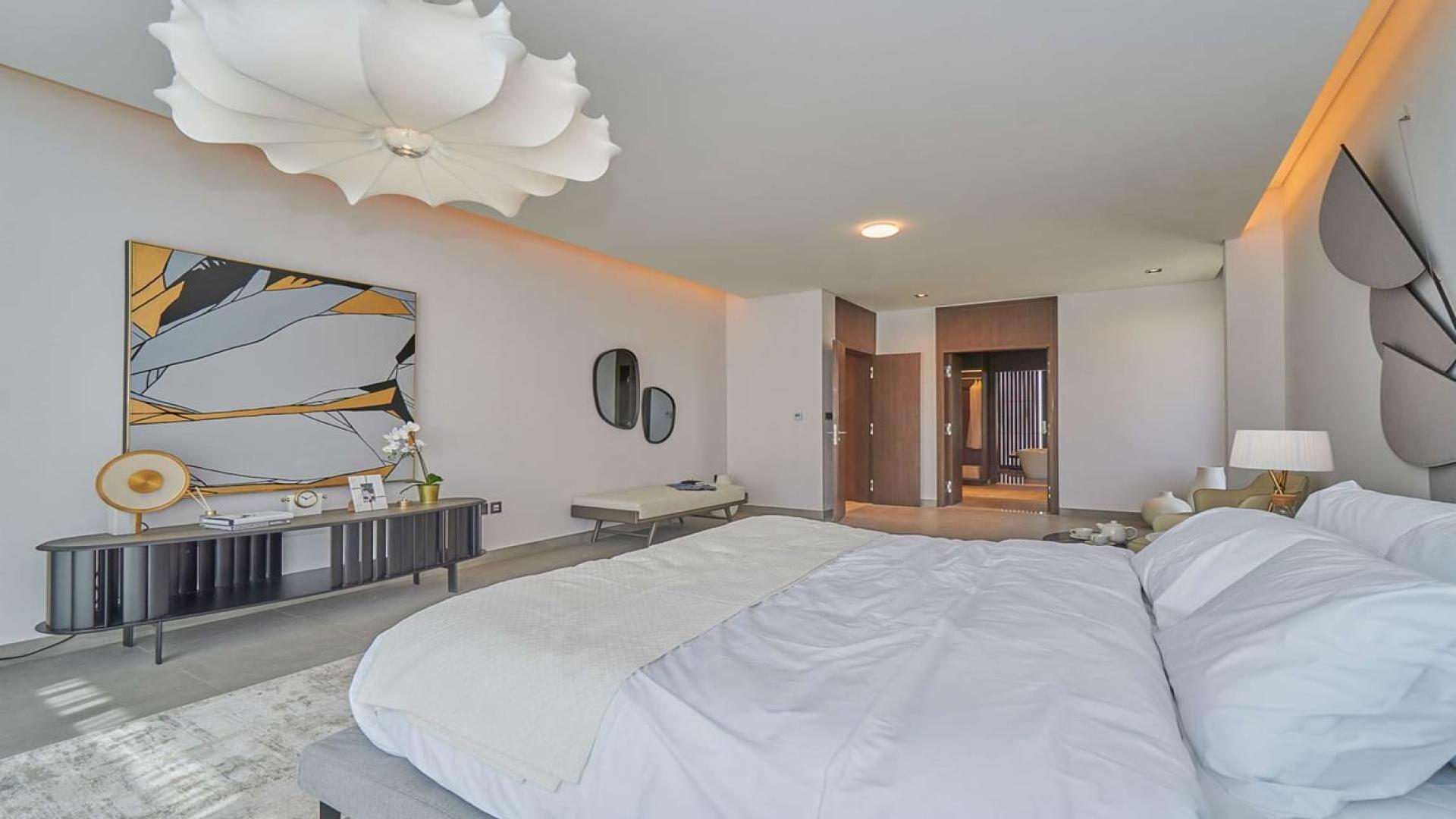 Elegant bedroom in Dubai Hills Estate villa, featuring modern decor and luxurious furnishings