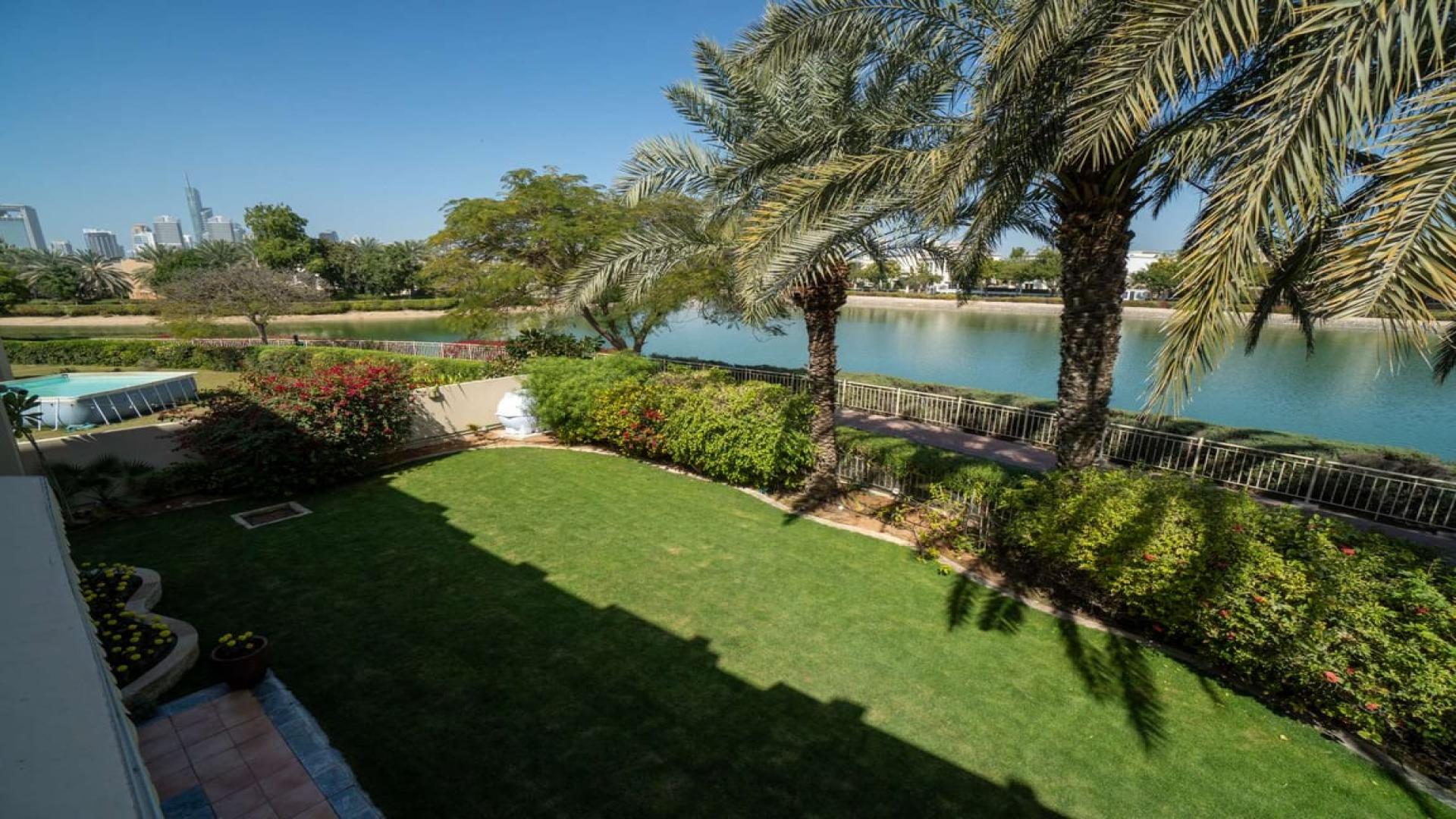 Exterior of five-bedroom villa in Meadows 5, Hattan, with garage and modern design