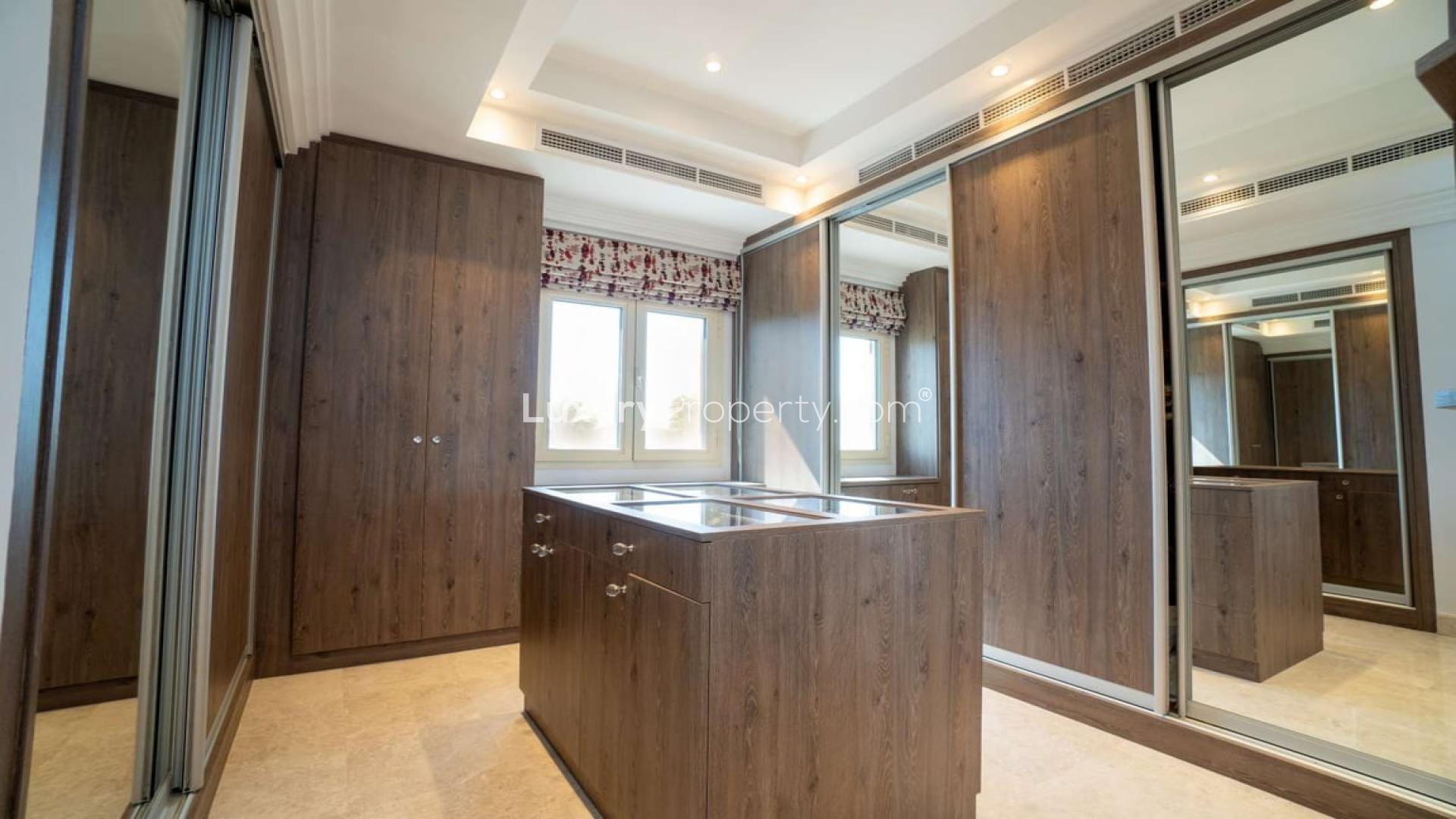 Luxurious living room in 5-bedroom villa, Meadows 5, with elegant furnishings and marble flooring