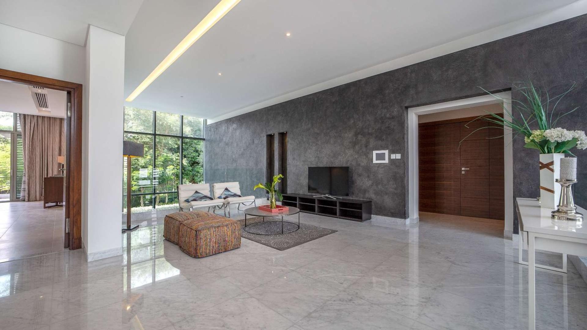 Luxurious living room in District One villa, featuring modern decor and large windows
