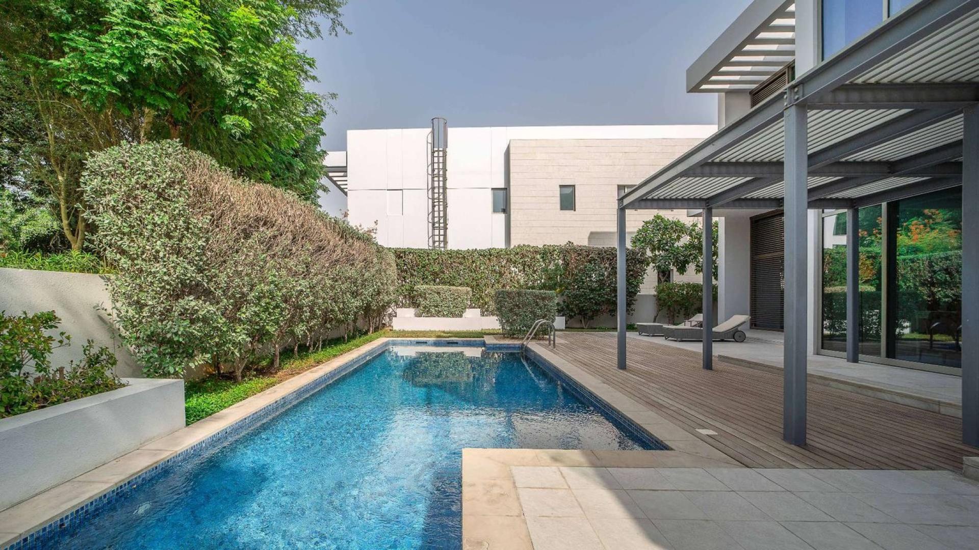 Contemporary villa interior with elegant dining area and large windows in District One