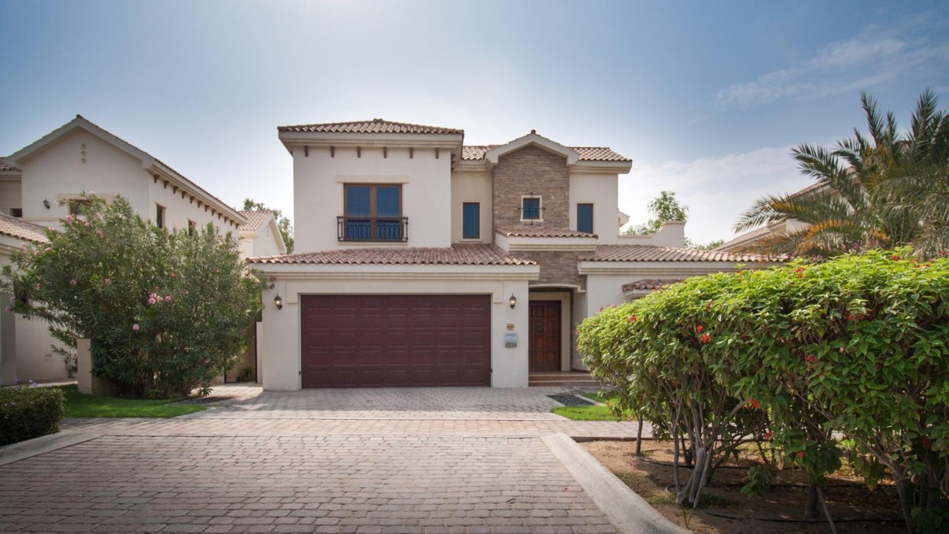 Empty room with large windows in Almeria Villa, Jumeirah Golf Estates, overlooking greenery