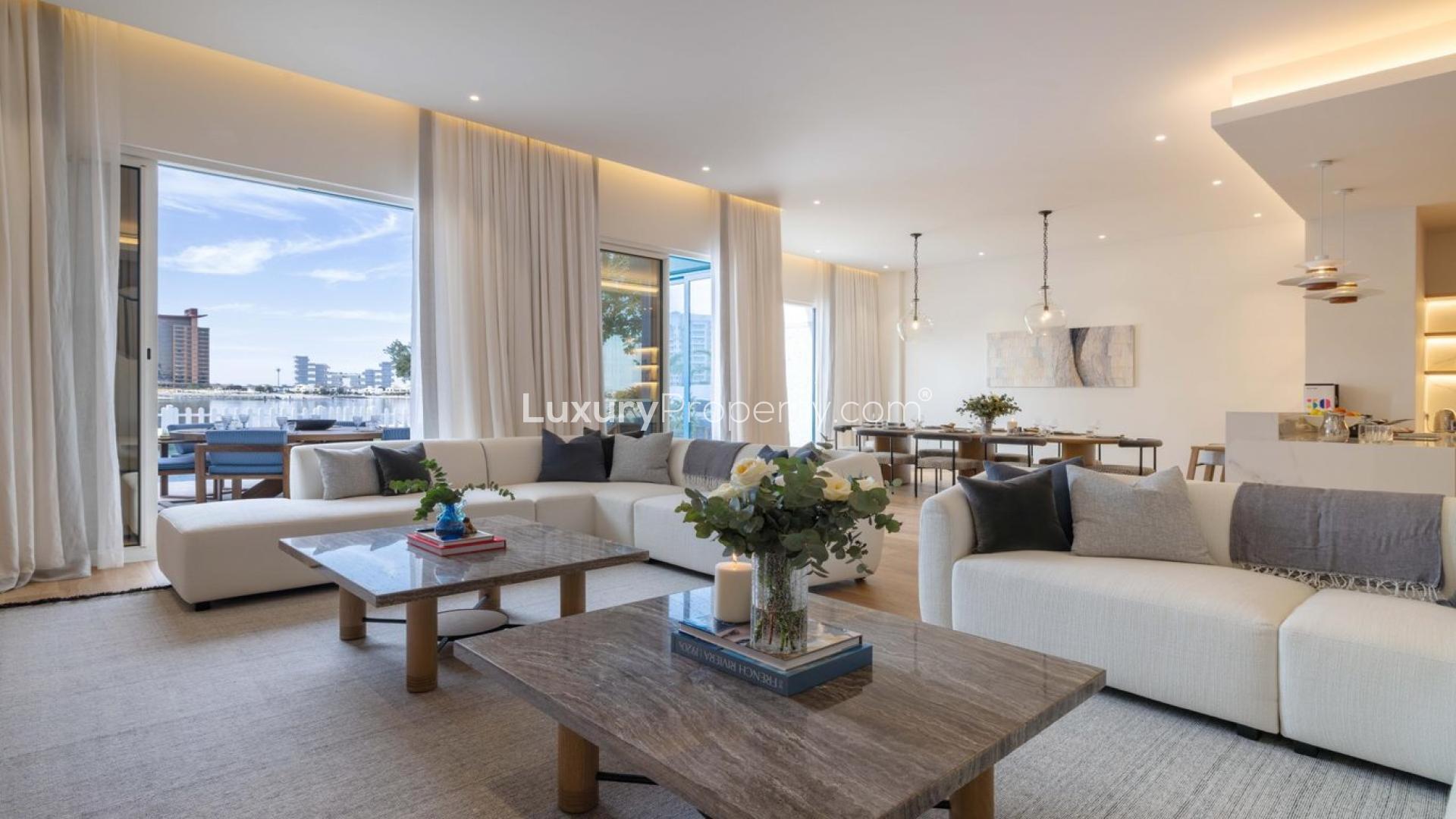 Beachfront villa poolside view at Palma Residences, Palm Jumeirah, with skyline backdrop