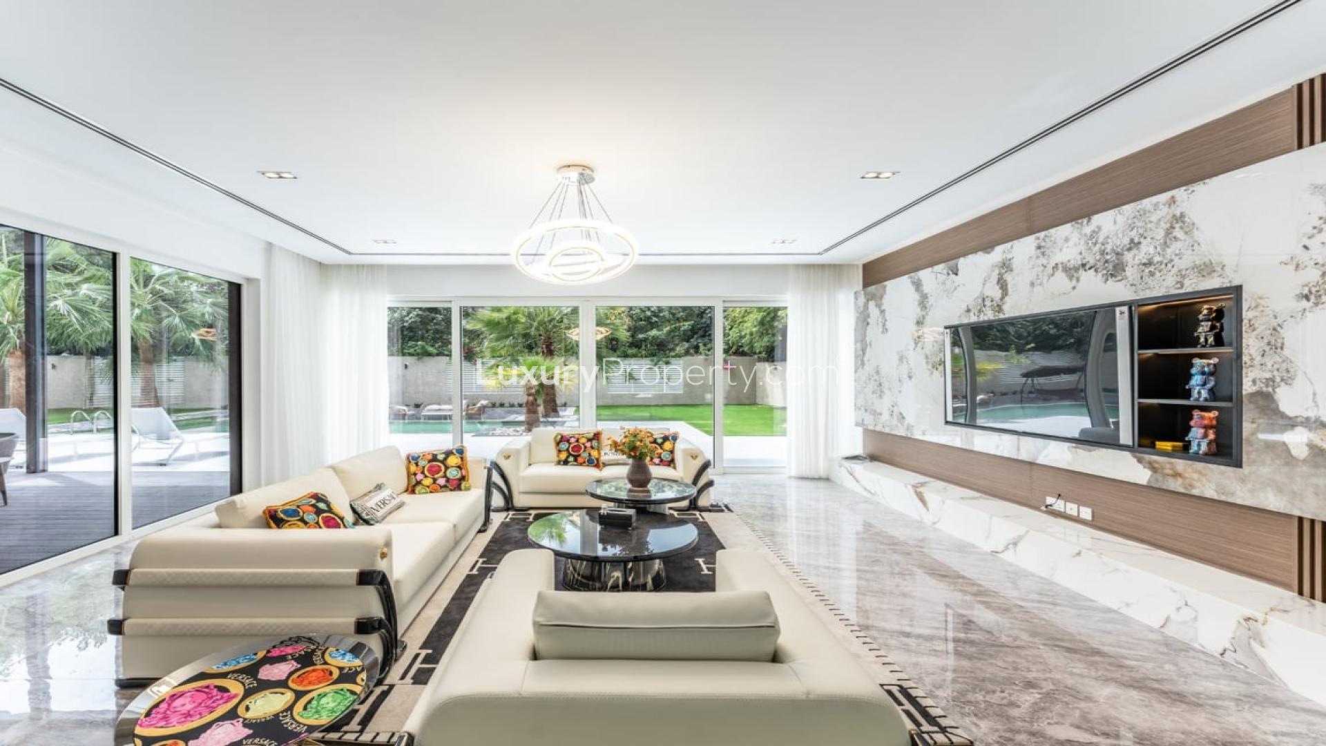 Luxurious living room in furnished Nest Villa, Al Barari, with pool view and modern decor