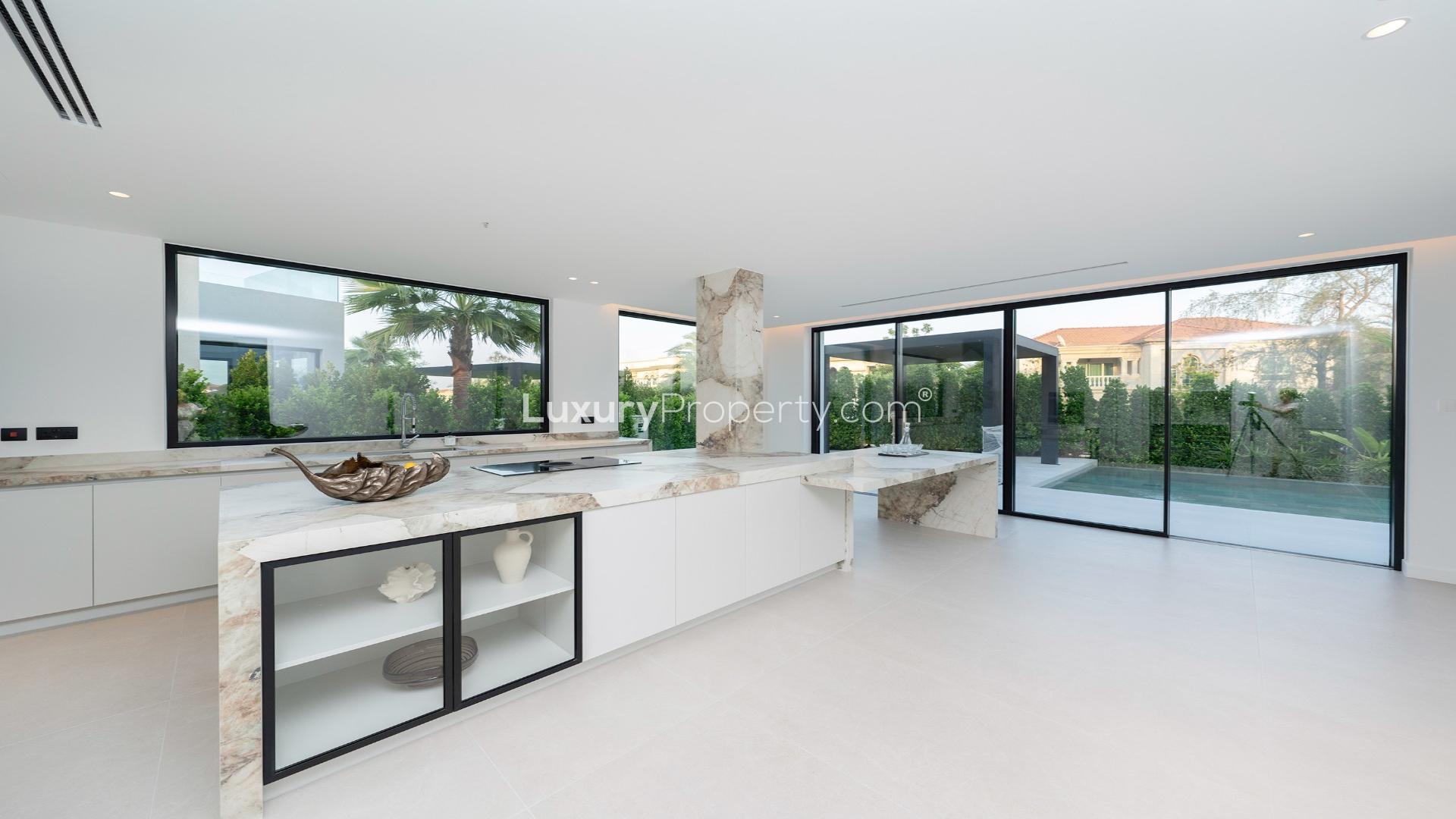 Contemporary living room in Miami-style villa, Jumeirah Islands, with pool view and modern decor