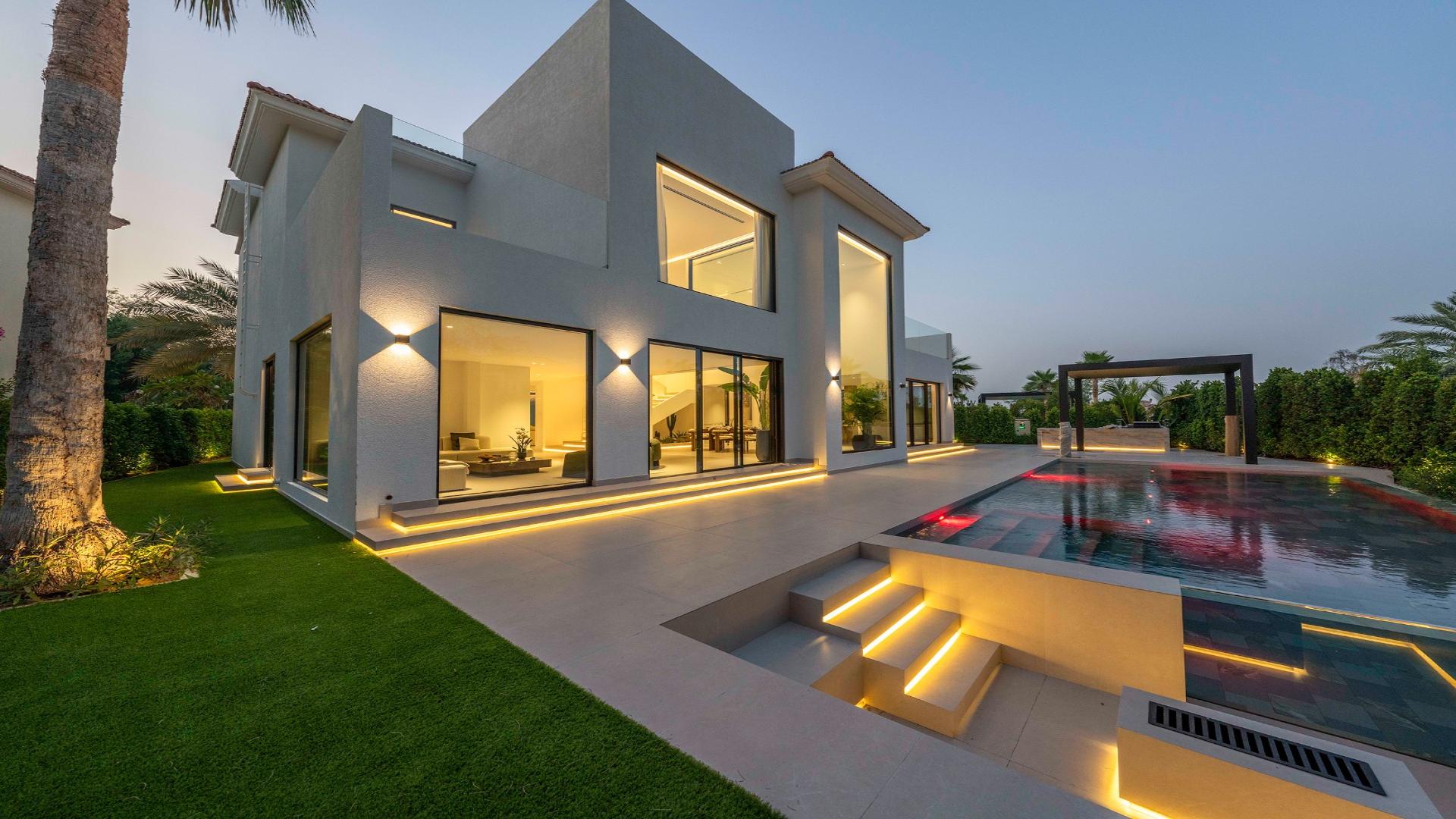 Contemporary Miami-style villa with pool, evening view, in Jumeirah Islands Mediterranean Clusters