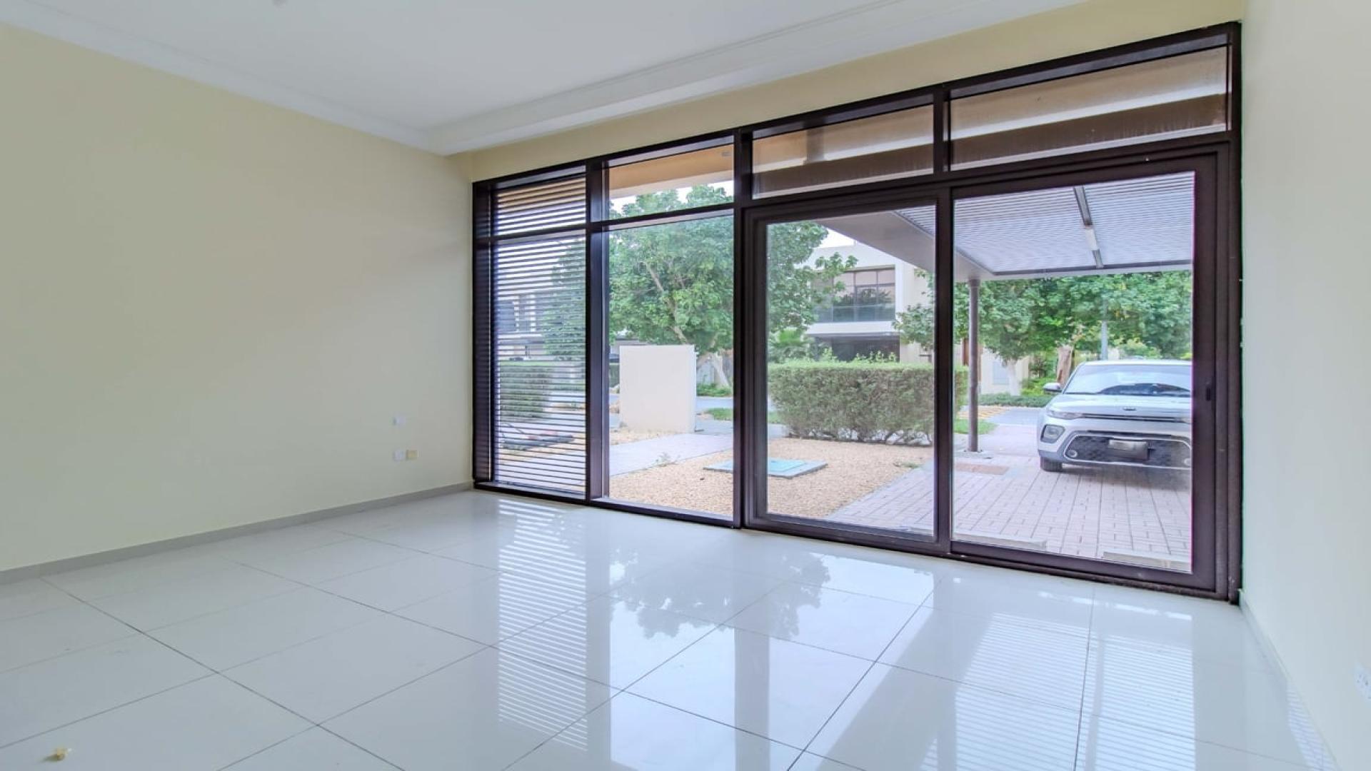 Spacious living room with large windows in Brookfield standalone corner villa, Damac Hills