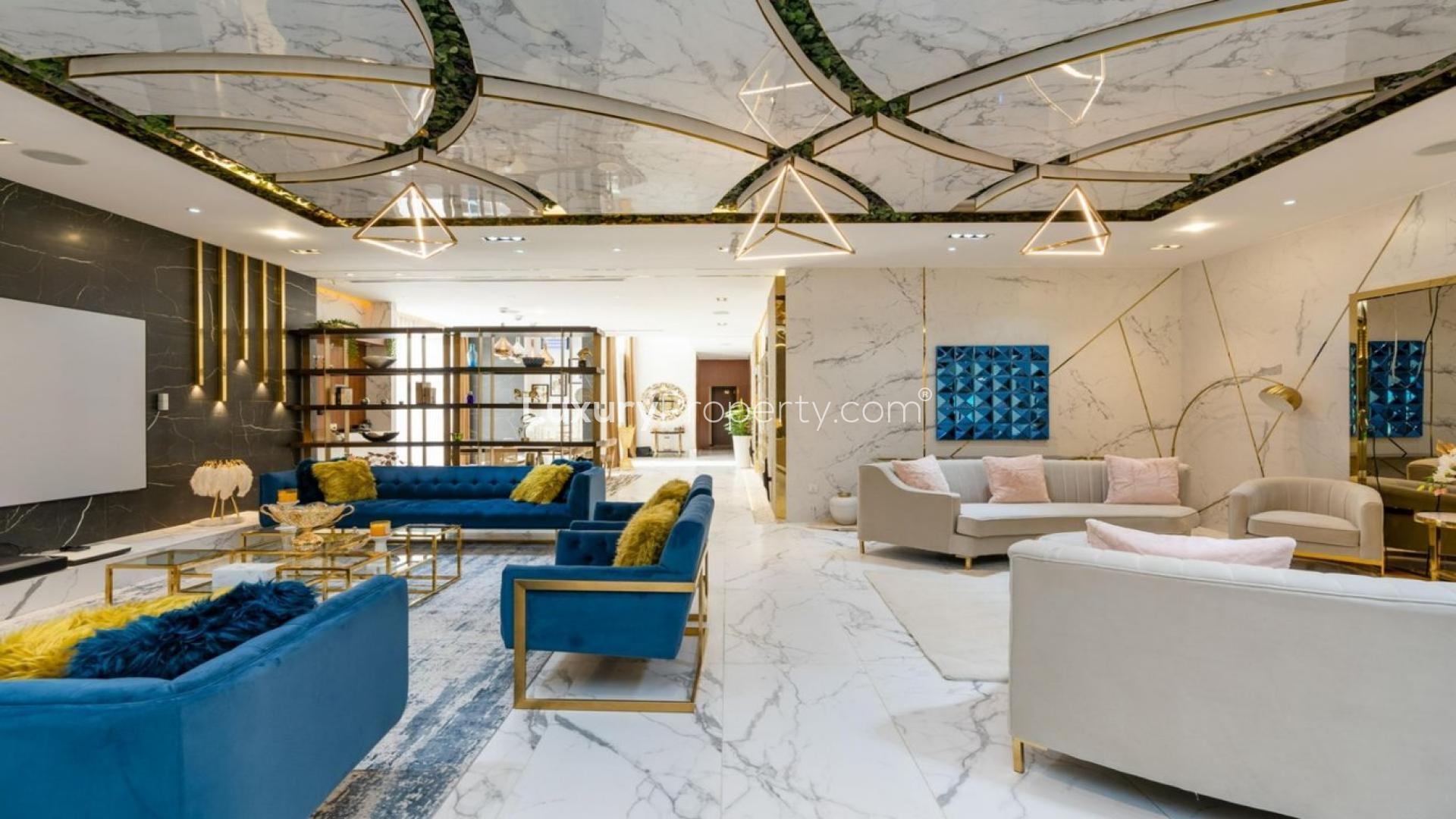 Luxury living room in VD1 Villa, Whitefield, Damac Hills with modern decor and blue sofas