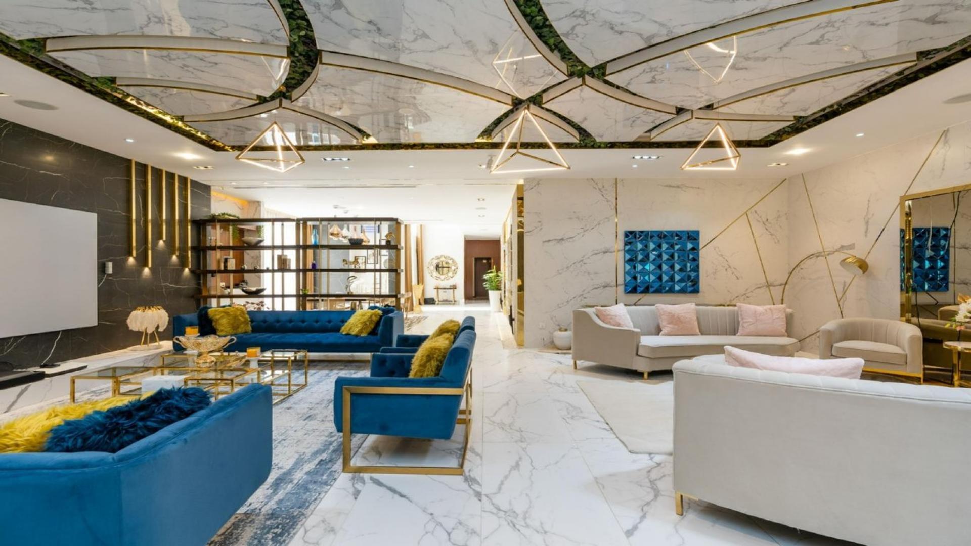 Luxury living room in VD1 Villa, Whitefield, Damac Hills with modern decor and blue sofas