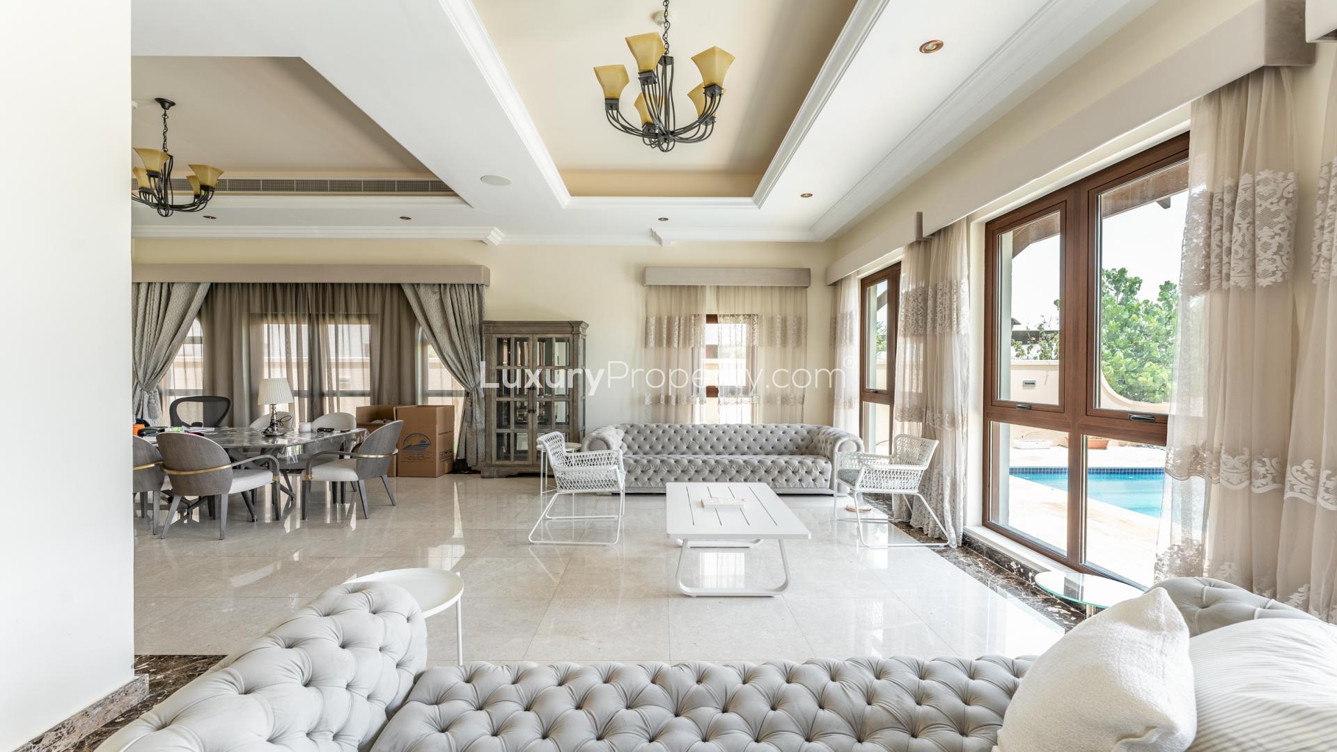 Luxurious villa living room with elegant decor and garden view in Jumeirah Golf Estates
