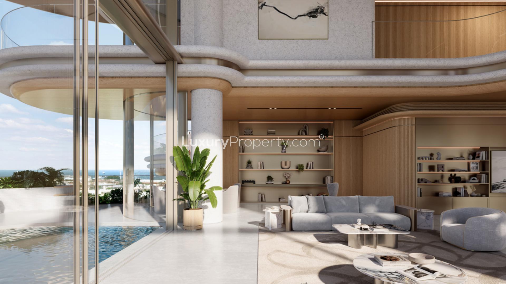 Futuristic luxury apartment building with curved balconies in Jumeirah's The Rings, nighttime view