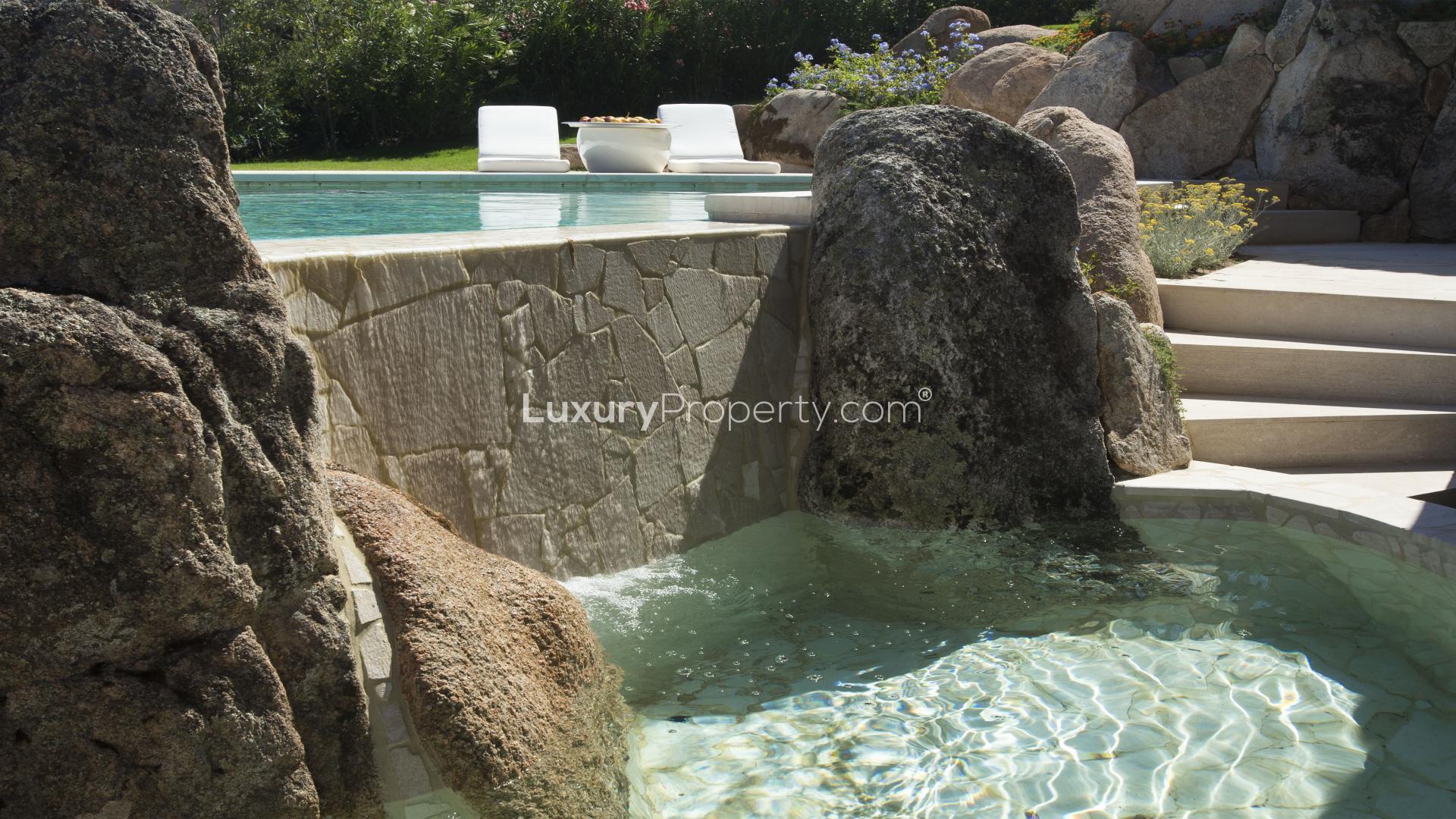 Luxury villa pool with stone waterfall in Acquamarina, Costa Smeralda