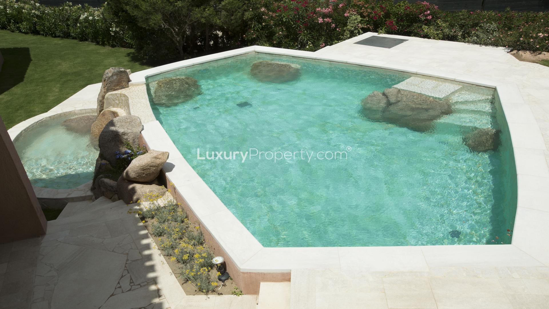 Elegant bedroom with pool view in luxury villa near Porto Cervo, Costa Smeralda