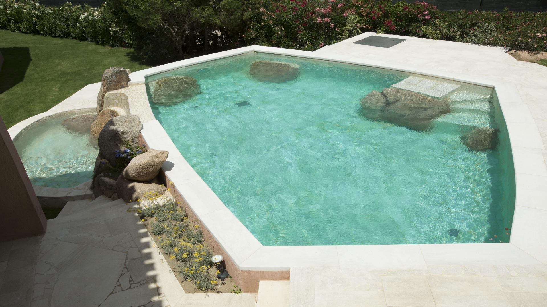 Elegant bedroom with pool view in luxury villa near Porto Cervo, Costa Smeralda