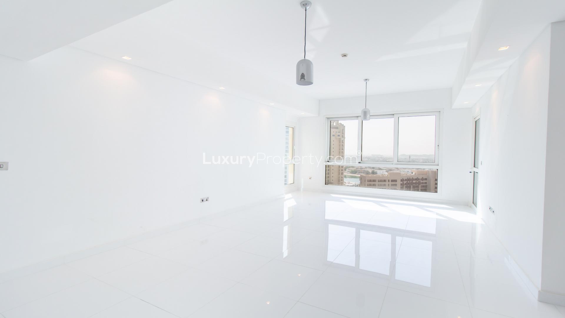 "Spacious balcony with city view in Palm Jumeirah apartment for sale, Marina Residences.","Spacious, light-filled living room in Palm Jumeirah apartment for sale, Marina Residences.",Light-filled room with large window view in Palm Jumeirah Marina Residences apartment
