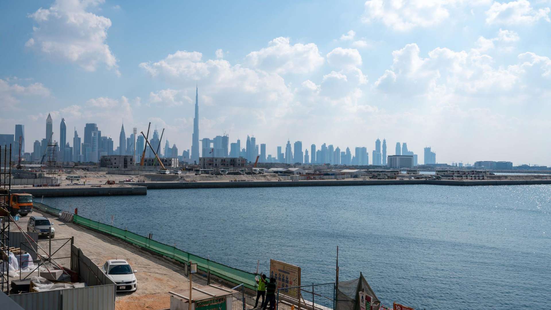 Empty apartment room with large window, offering stunning marina and Dubai skyline views