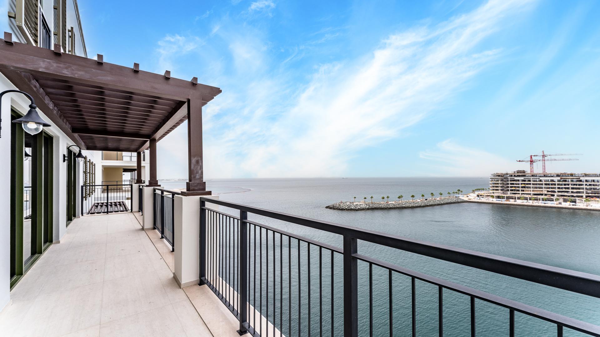 "Modern kitchen with Dubai skyline view, 5-bedroom apartment, La Mer Le Ciel, Jumeirah.",Balcony view from 5-bedroom apartment at La Mer Le Ciel, Jumeirah, overlooking the sea