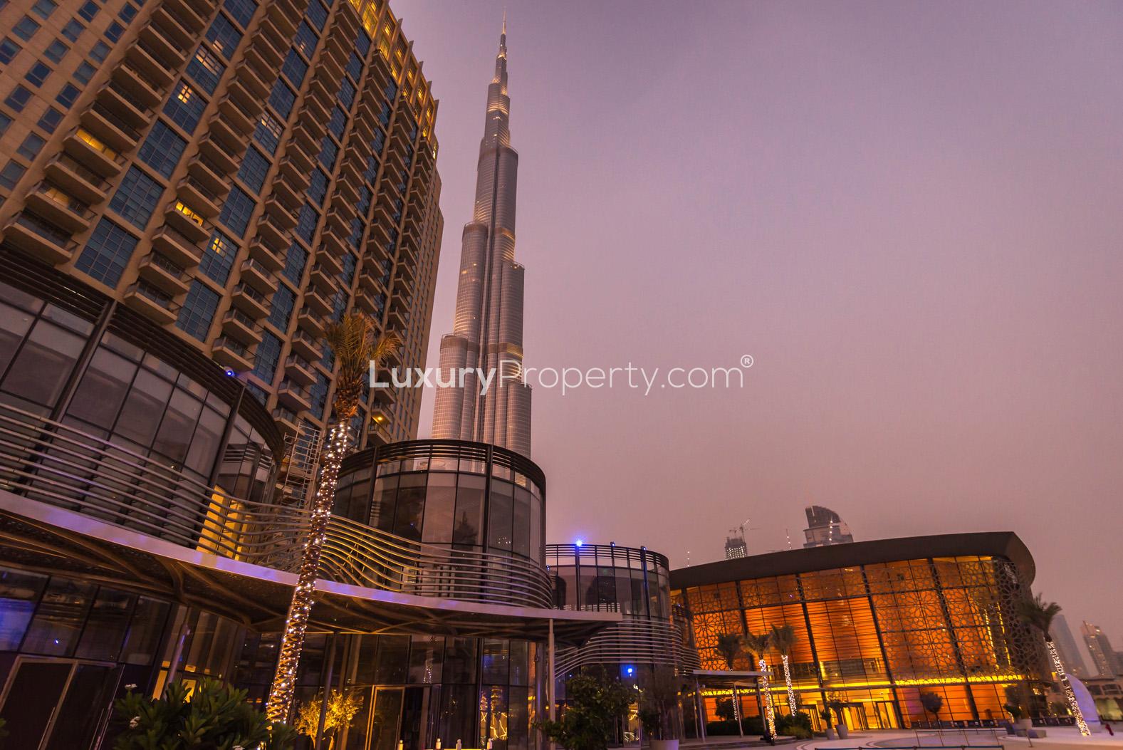 Night view of The Address Residences Dubai Opera, Downtown Dubai skyline, illuminated palm trees