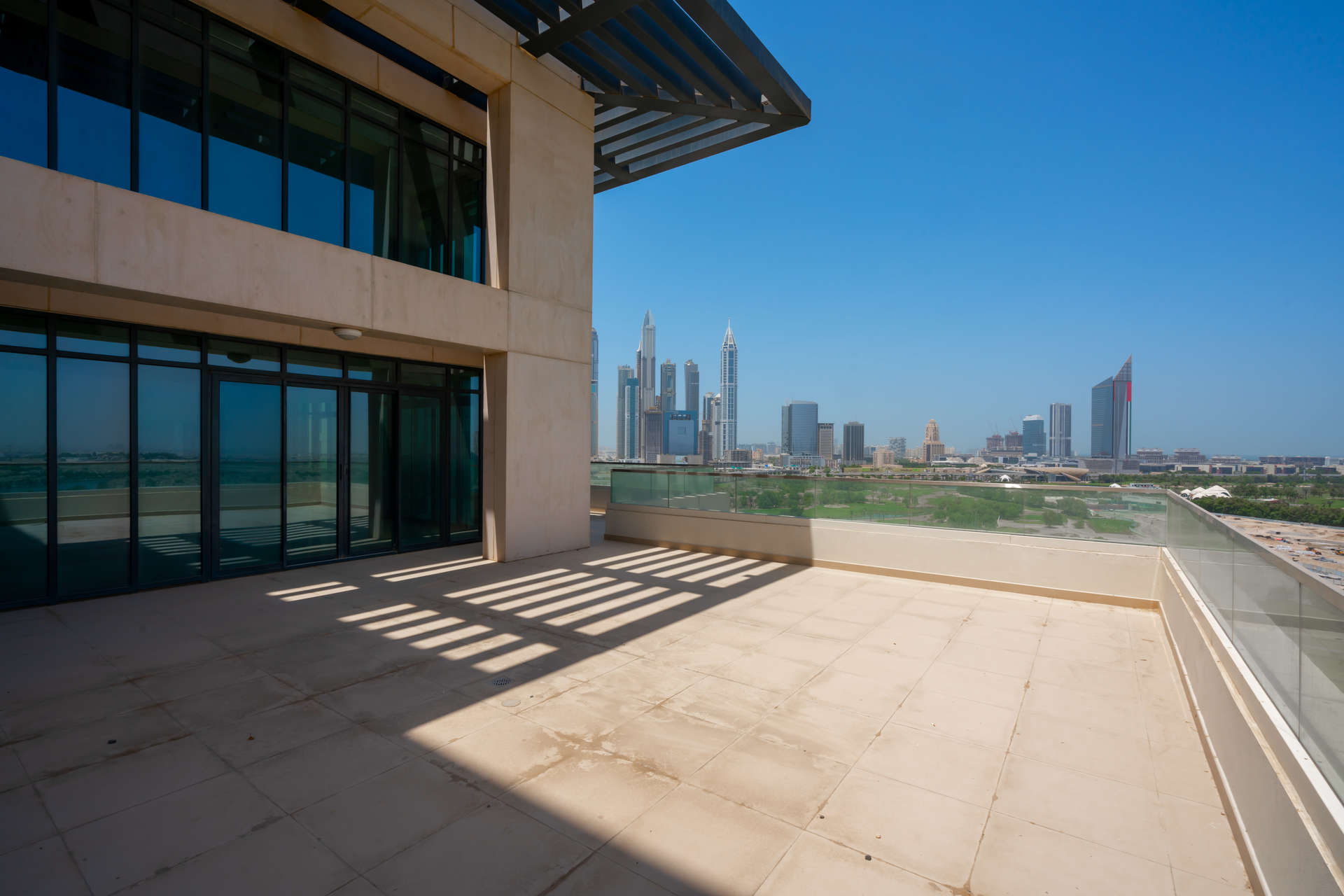 Spacious living area with floor-to-ceiling windows in The Hills duplex penthouse, Dubai