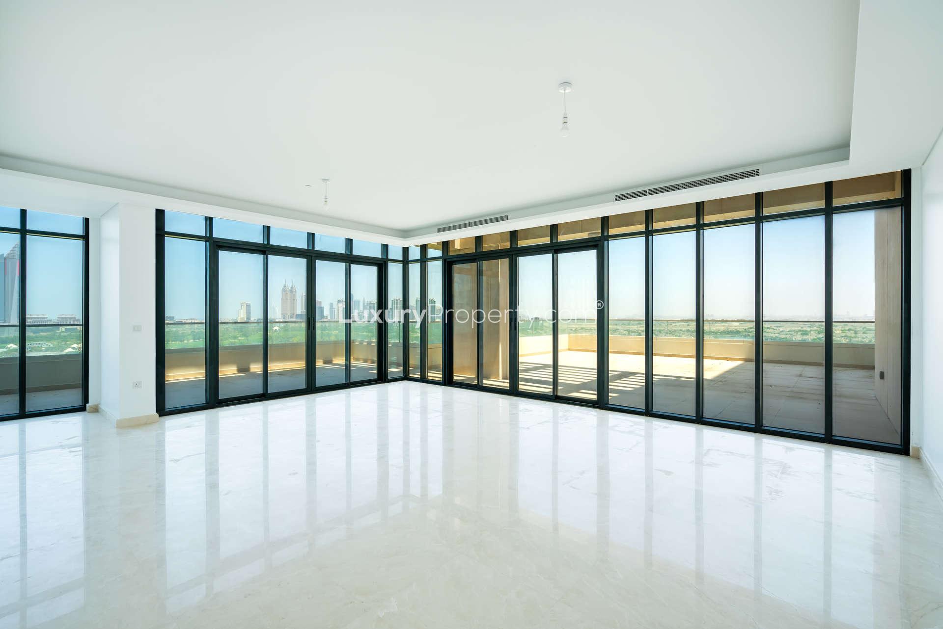 Spacious living area with floor-to-ceiling windows in five-bedroom penthouse, The Hills Dubai