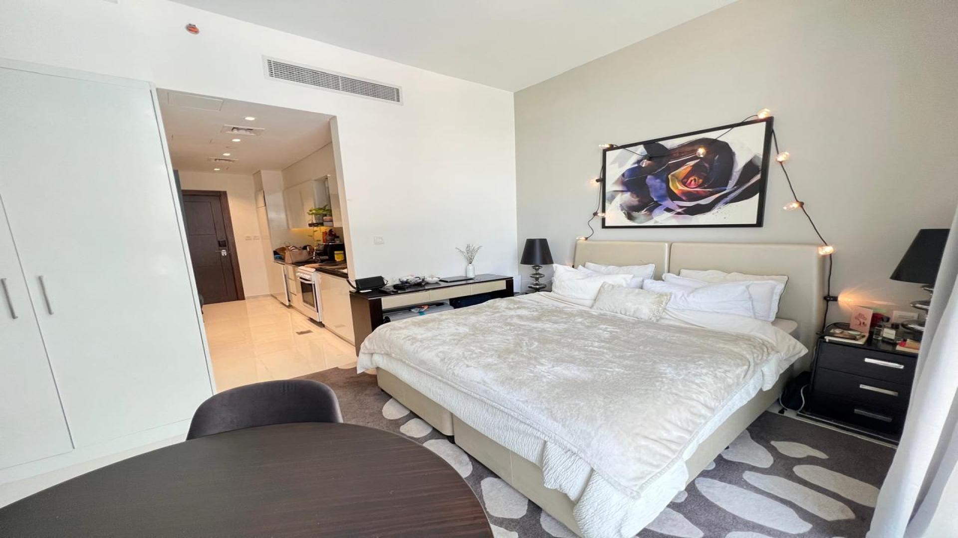 Fully furnished studio apartment interior in Golf Promenade, Damac Hills, featuring modern decor