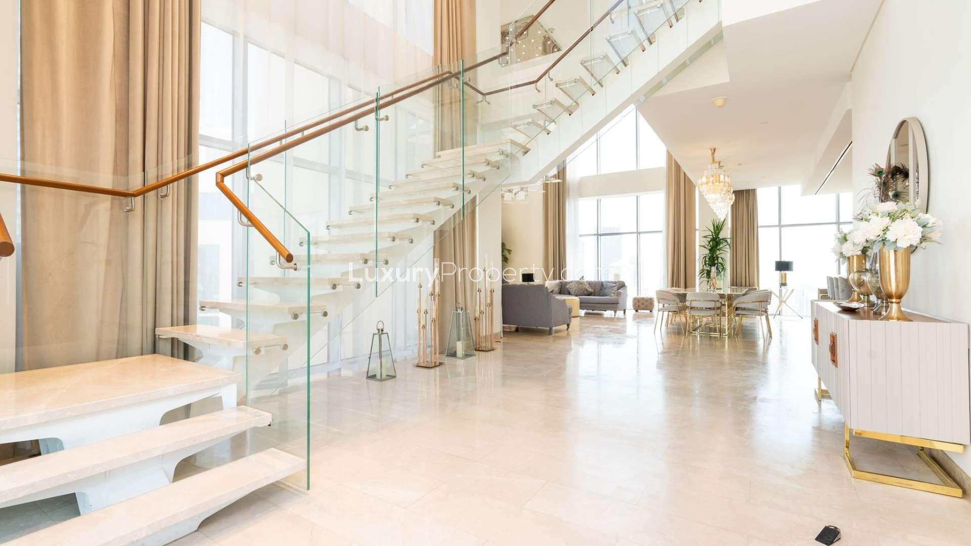 Luxurious living room in 5-bedroom duplex penthouse, Downtown Dubai, with modern decor and views