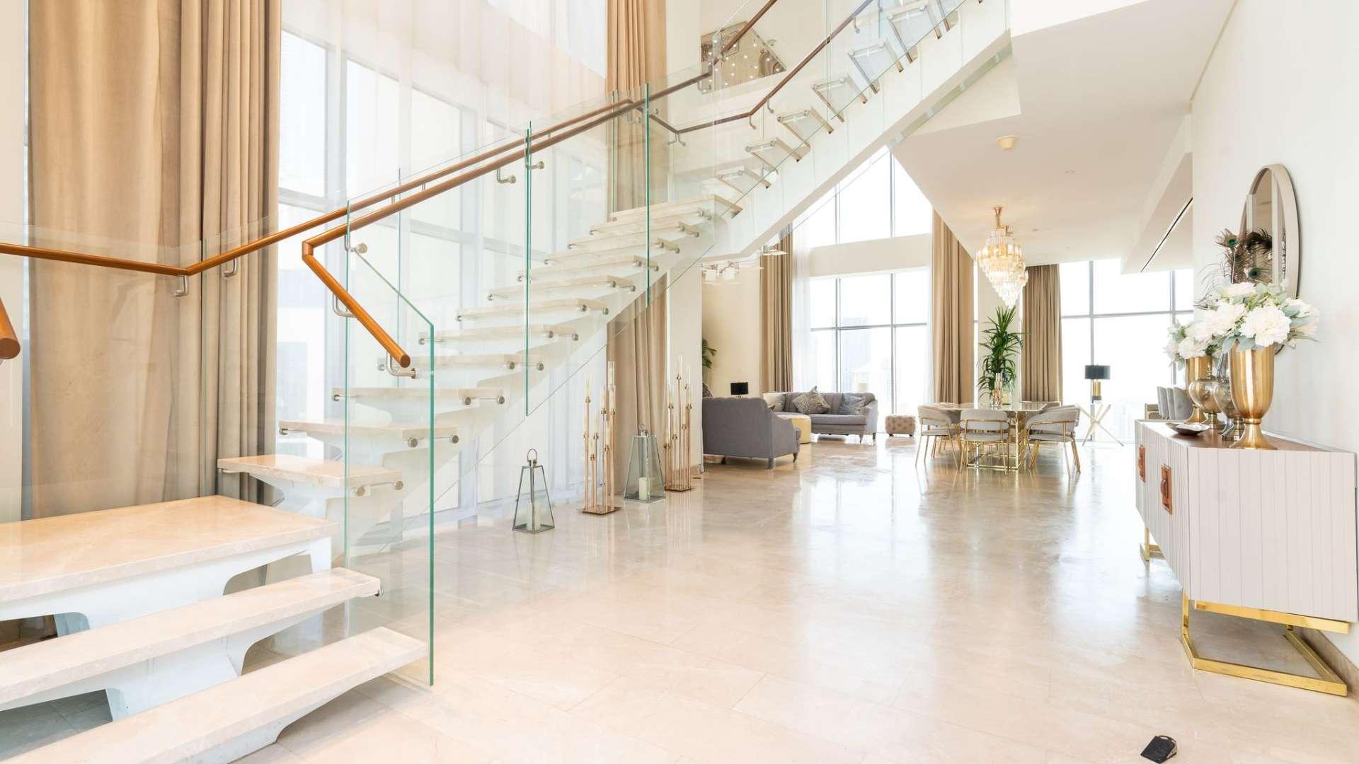 Luxurious living room in 5-bedroom duplex penthouse, Downtown Dubai, with modern decor and views