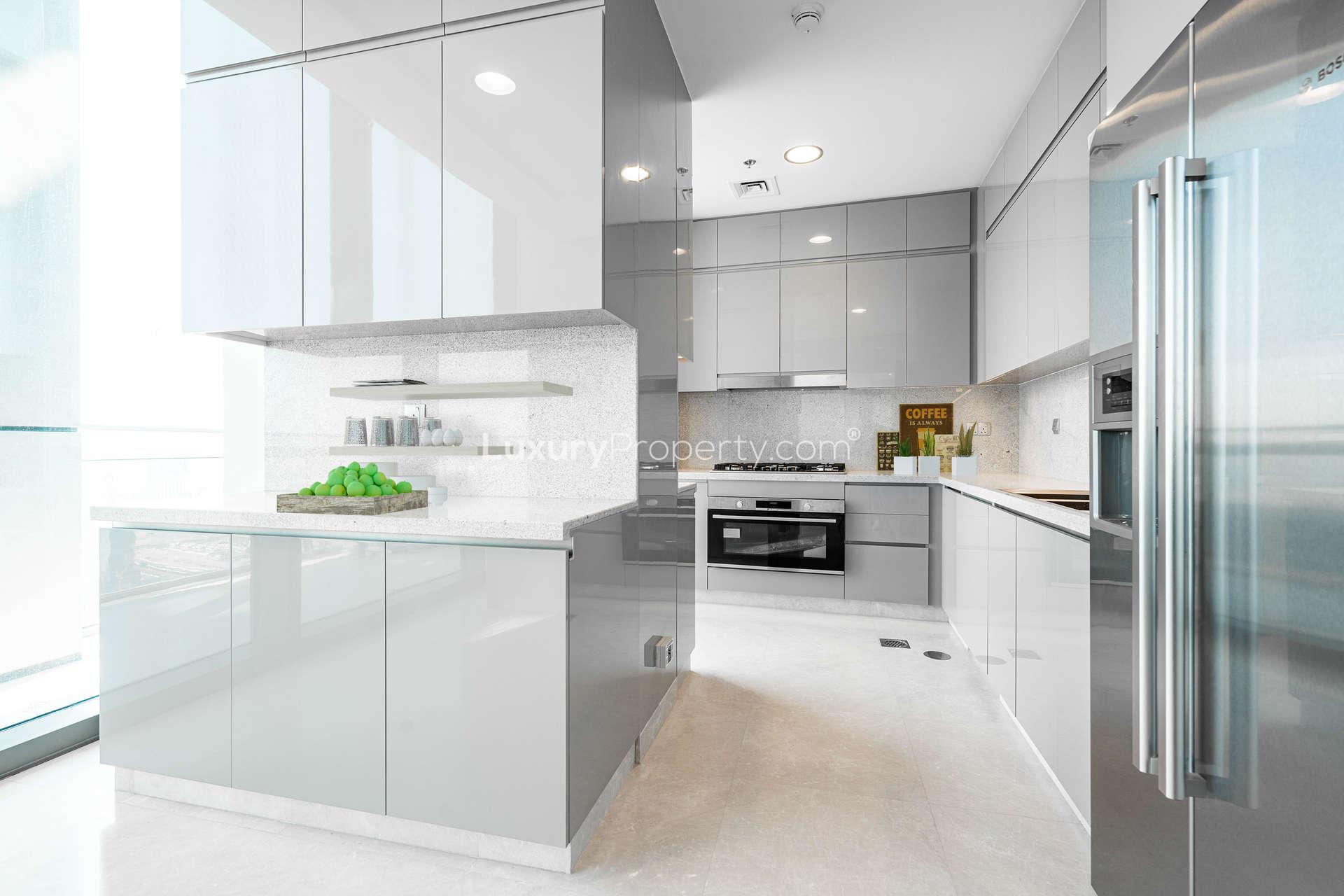 "Stunning Burj Khalifa view from Burj Vista duplex penthouse balcony, Downtown Dubai rental.",Modern kitchen in duplex penthouse, Burj Vista, Downtown Dubai with sleek cabinetry and appliances