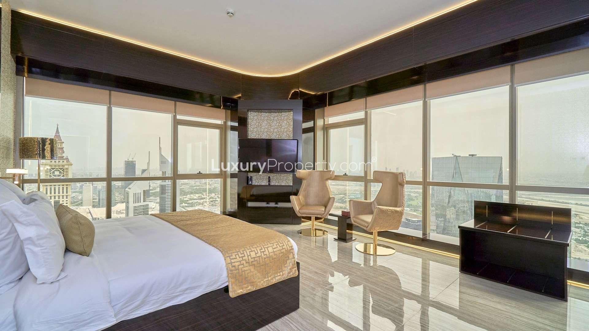 Luxurious bedroom in DIFC penthouse with city view, elegant decor, and modern furnishings
