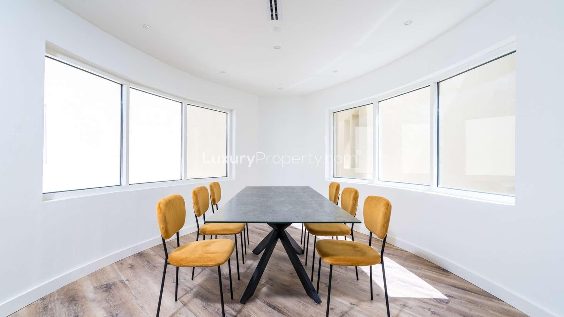 Spacious living room in 5-bedroom Jumeirah Lake Towers penthouse with modern furnishings and natural light