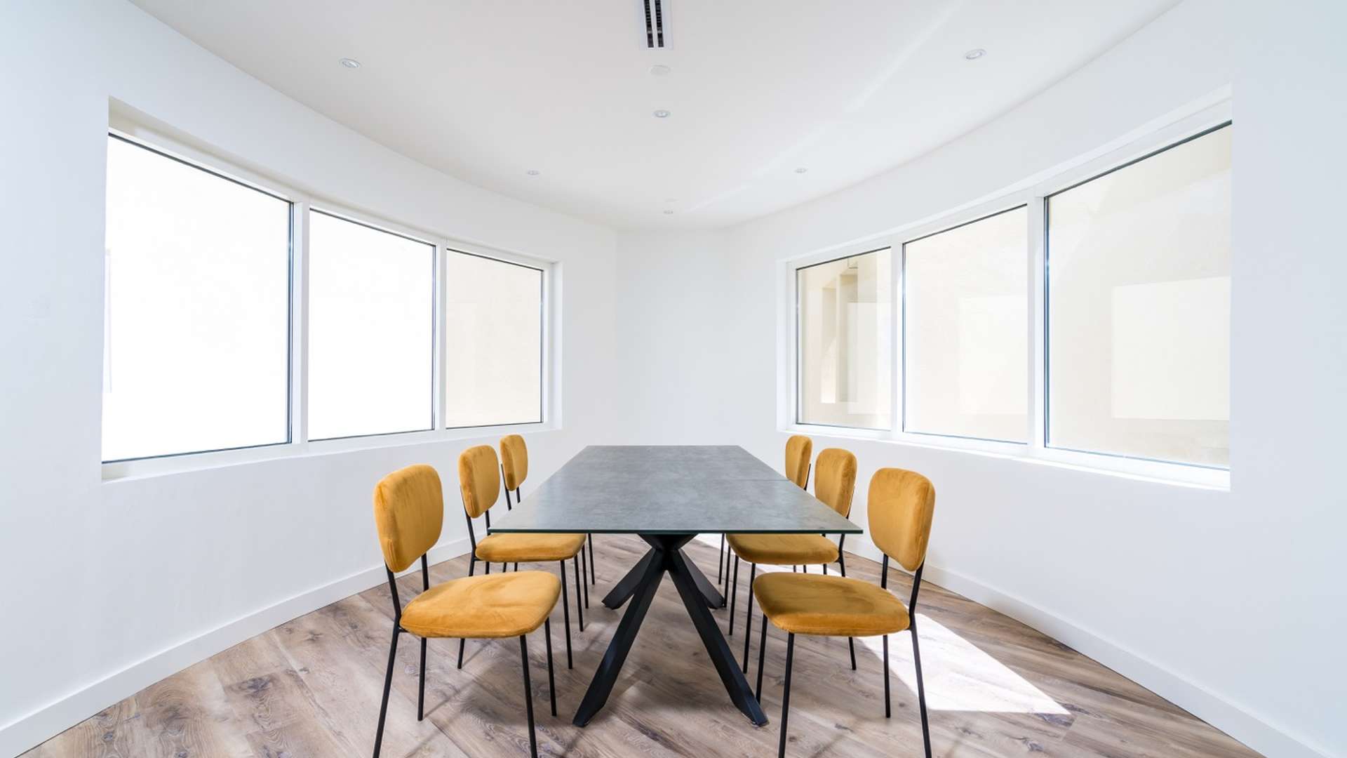 Spacious living room in 5-bedroom Jumeirah Lake Towers penthouse with modern furnishings and natural light