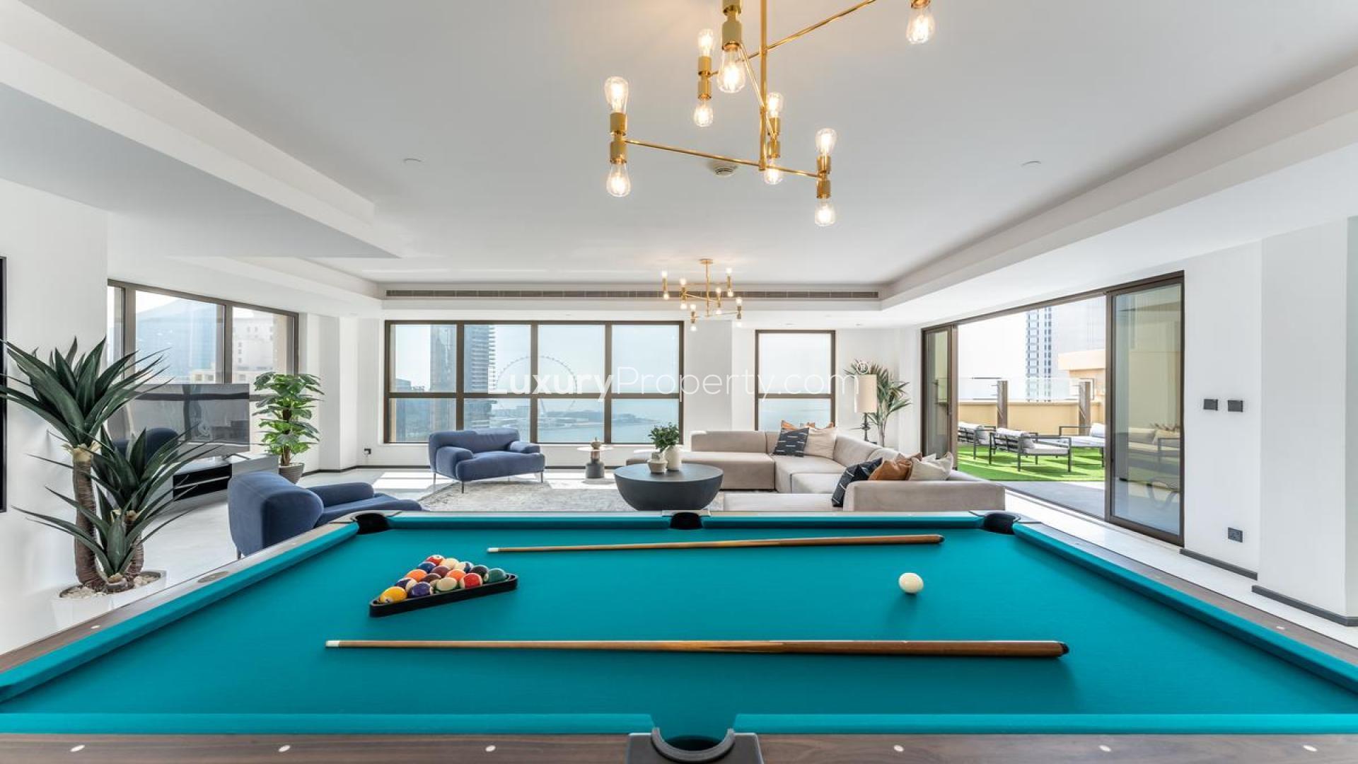 Luxurious open-plan living area with pool table in Jumeirah Beach Residence penthouse