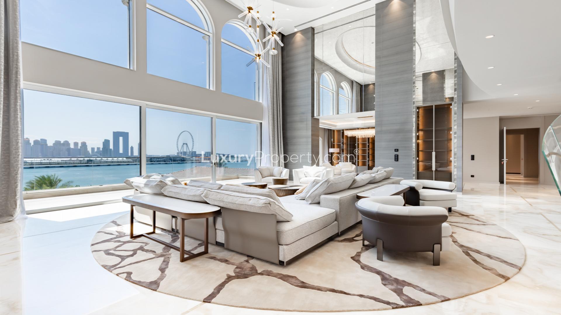 Luxurious living room in XXII Carat Palm Jumeirah villa with modern furnishings and staircase