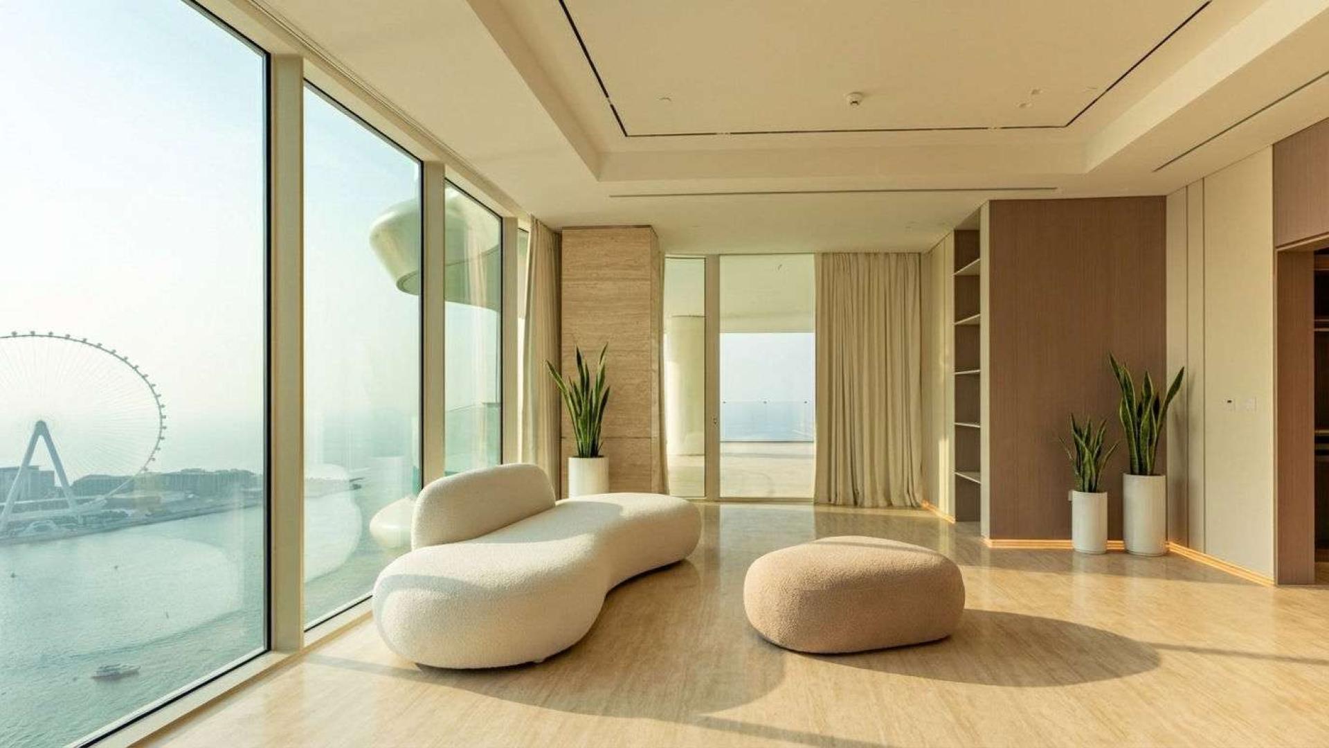 Luxurious penthouse terrace with infinity pool, sea view, and Ain Dubai at sunset